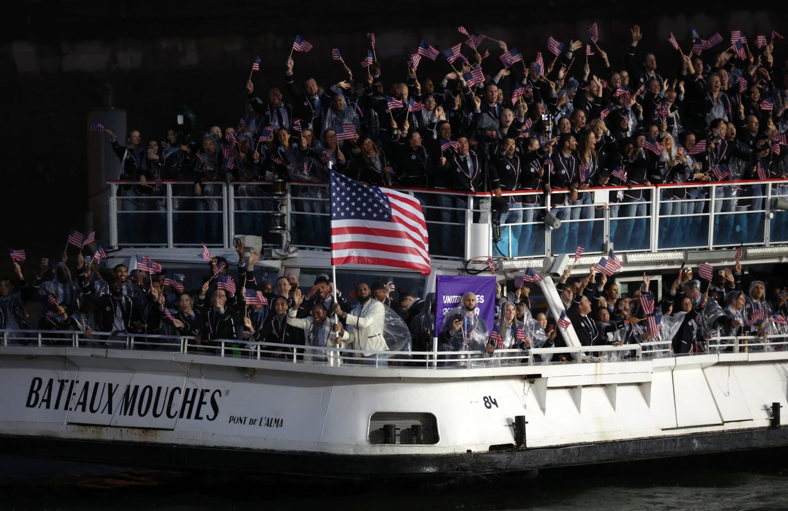 PARIS, FRANCE - JULY 26: Coco Gauff and Lebron James, Flagbearers of Team United States, are seen on a boat waving their flag along the River Seine during the opening ceremony of the Olympic Games Paris 2024 on July 26, 2024 in Paris, France. (Photo by Alex Broadway/Getty Images) PARIS, FRANCE - JULY 26: Coco Gauff and Lebron James, Flagbearers of Team United States, are seen on a boat waving their flag along the River Seine during the opening ceremony of the Olympic Games Paris 2024 on July 26, 2024 in Paris, France. (Photo by Alex Broadway/Getty Images)