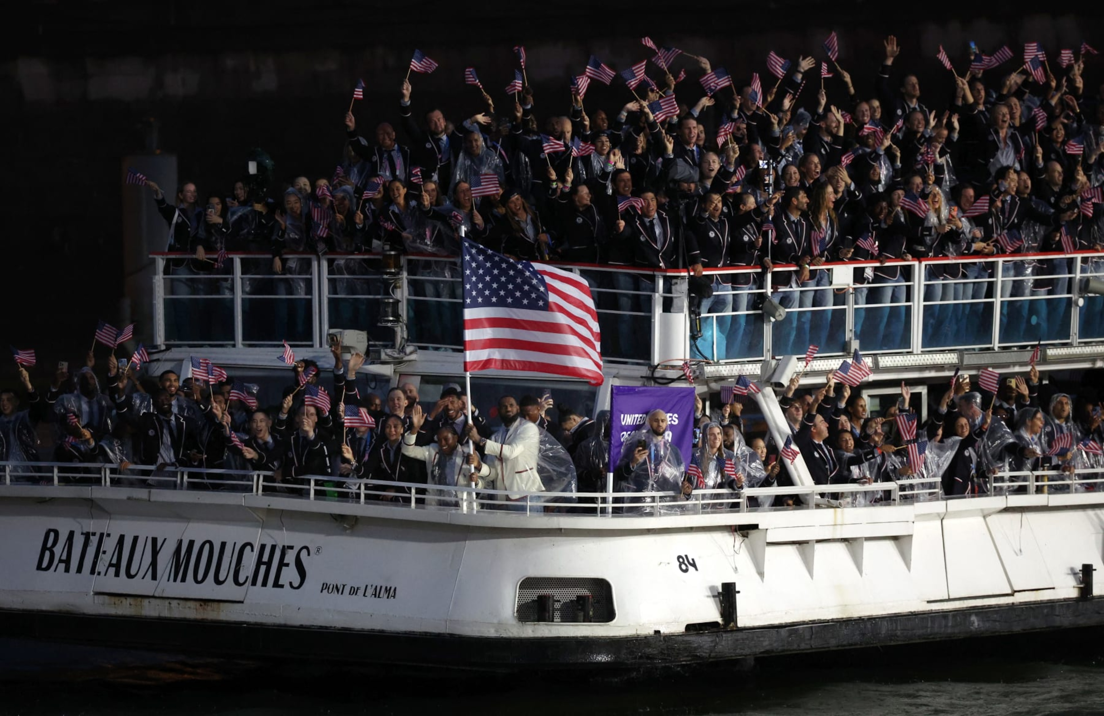 PARIS, FRANCE - JULY 26: Coco Gauff and Lebron James, Flagbearers of Team United States, are seen on a boat waving their flag along the River Seine during the opening ceremony of the Olympic Games Paris 2024 on July 26, 2024 in Paris, France. (Photo by Alex Broadway/Getty Images) PARIS, FRANCE - JULY 26: Coco Gauff and Lebron James, Flagbearers of Team United States, are seen on a boat waving their flag along the River Seine during the opening ceremony of the Olympic Games Paris 2024 on July 26, 2024 in Paris, France. (Photo by Alex Broadway/Getty Images)