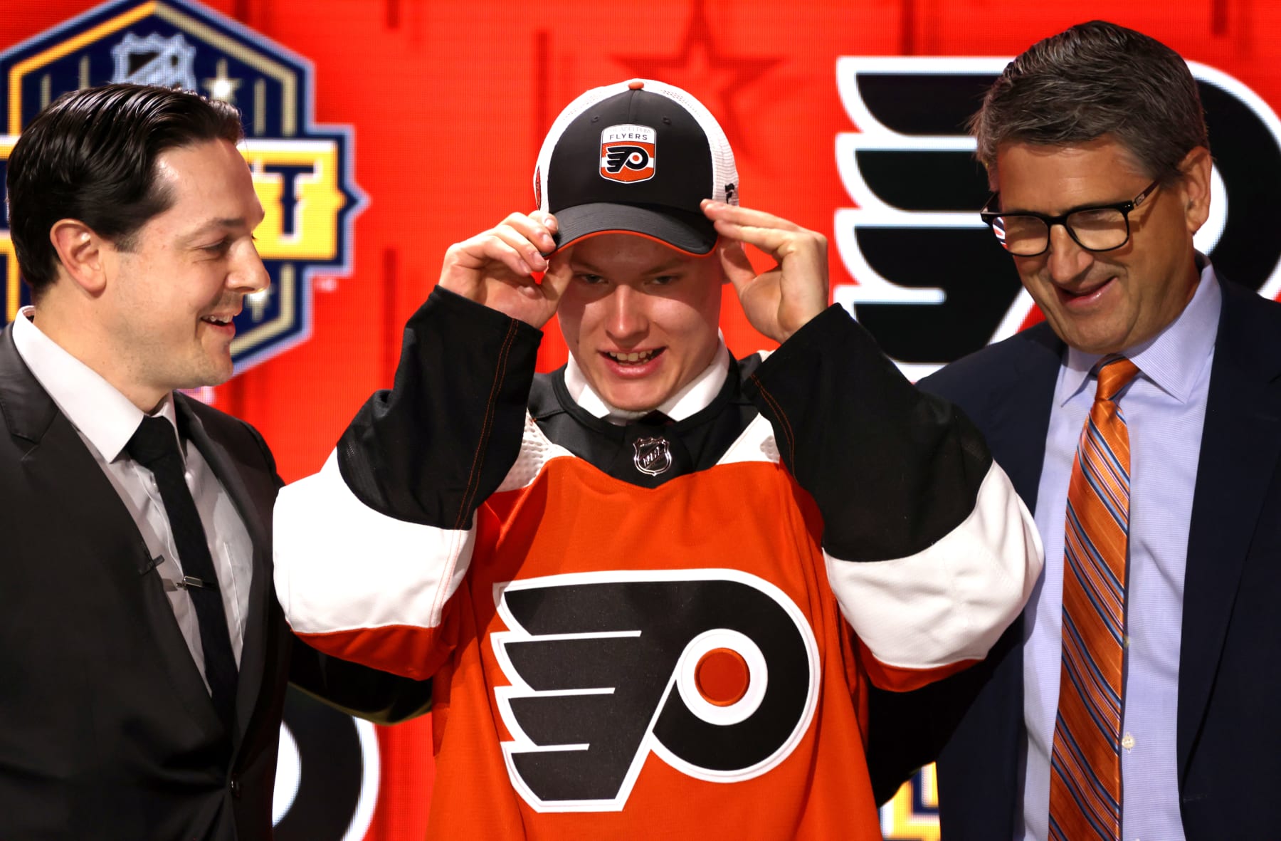 NASHVILLE, TENNESSEE - JUNE 28: Matvei Michkov stands onstage with general manager Daniel Briere and Keith Jones after being selected seventh overall by the Philadelphia Flyers the 2023 Upper Deck NHL Draft - Round One at Bridgestone Arena on June 28, 2023 in Nashville, Tennessee. (Photo by Dave Sandford/NHLI via Getty Images)