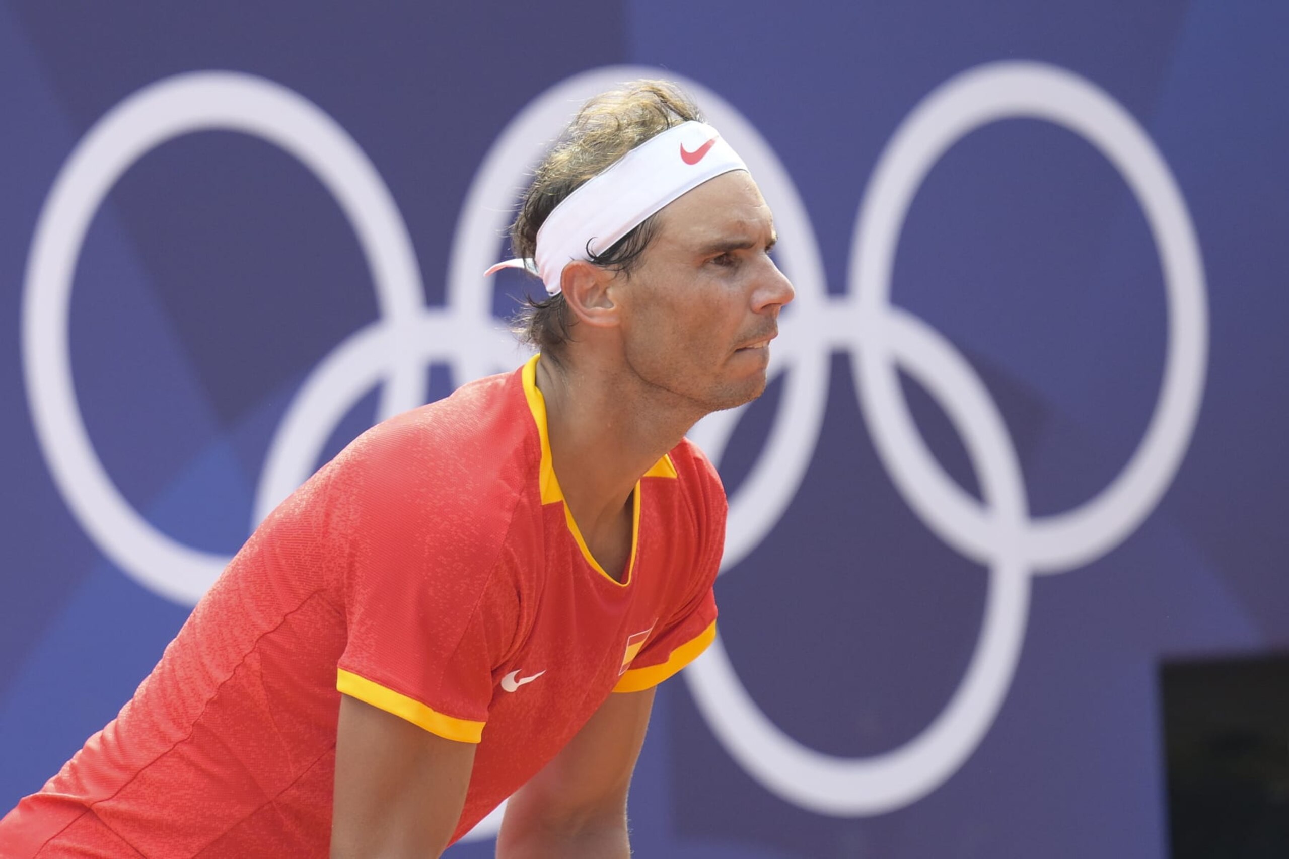 PARIS, FRANCE - JULY 28: Spain's Rafael Nadal and Hungary's Marton Fucsovics (not seen) compete during their men's singles first round tennis match on Court Philippe-Chatrier at the Roland-Garros Stadium at the Paris 2024 Olympic Games, in Paris, France on July 28, 2024. (Photo by Mehmet Murat Onel/Anadolu via Getty Images) PARIS, FRANCE - JULY 28: Spain's Rafael Nadal and Hungary's Marton Fucsovics (not seen) compete during their men's singles first round tennis match on Court Philippe-Chatrier at the Roland-Garros Stadium at the Paris 2024 Olympic Games, in Paris, France on July 28, 2024. (Photo by Mehmet Murat Onel/Anadolu via Getty Images)