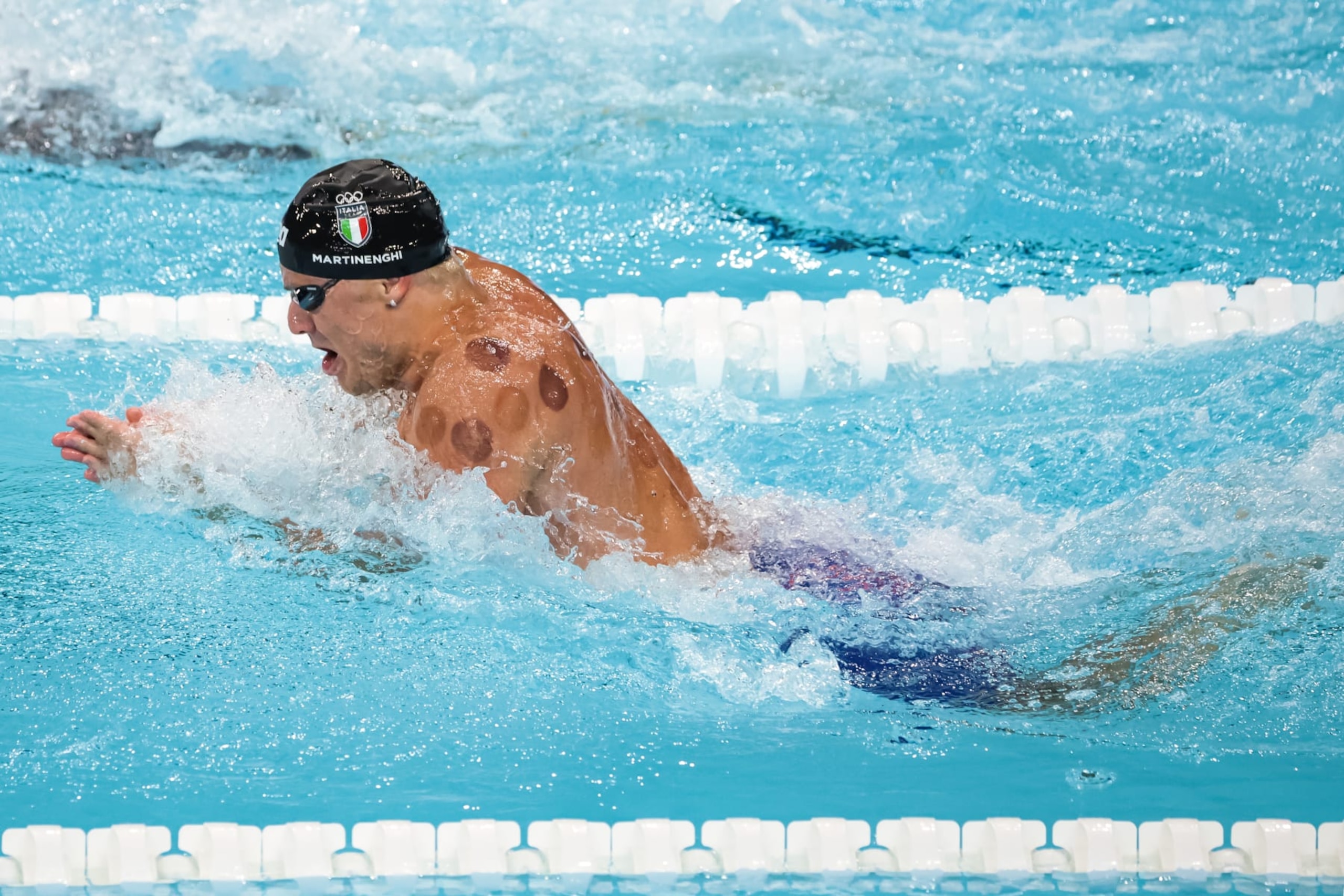 NANTERRE, FRANCE - JULY 27: Nicolò Martinenghi of Team Italy competes in the Men's 100m Breaststroke Heats on day one of the Olympic Games Paris 2024 at Paris La Defense Arena on July 27, 2024 in Nanterre, France. (Photo by Jean Catuffe/Getty Images)