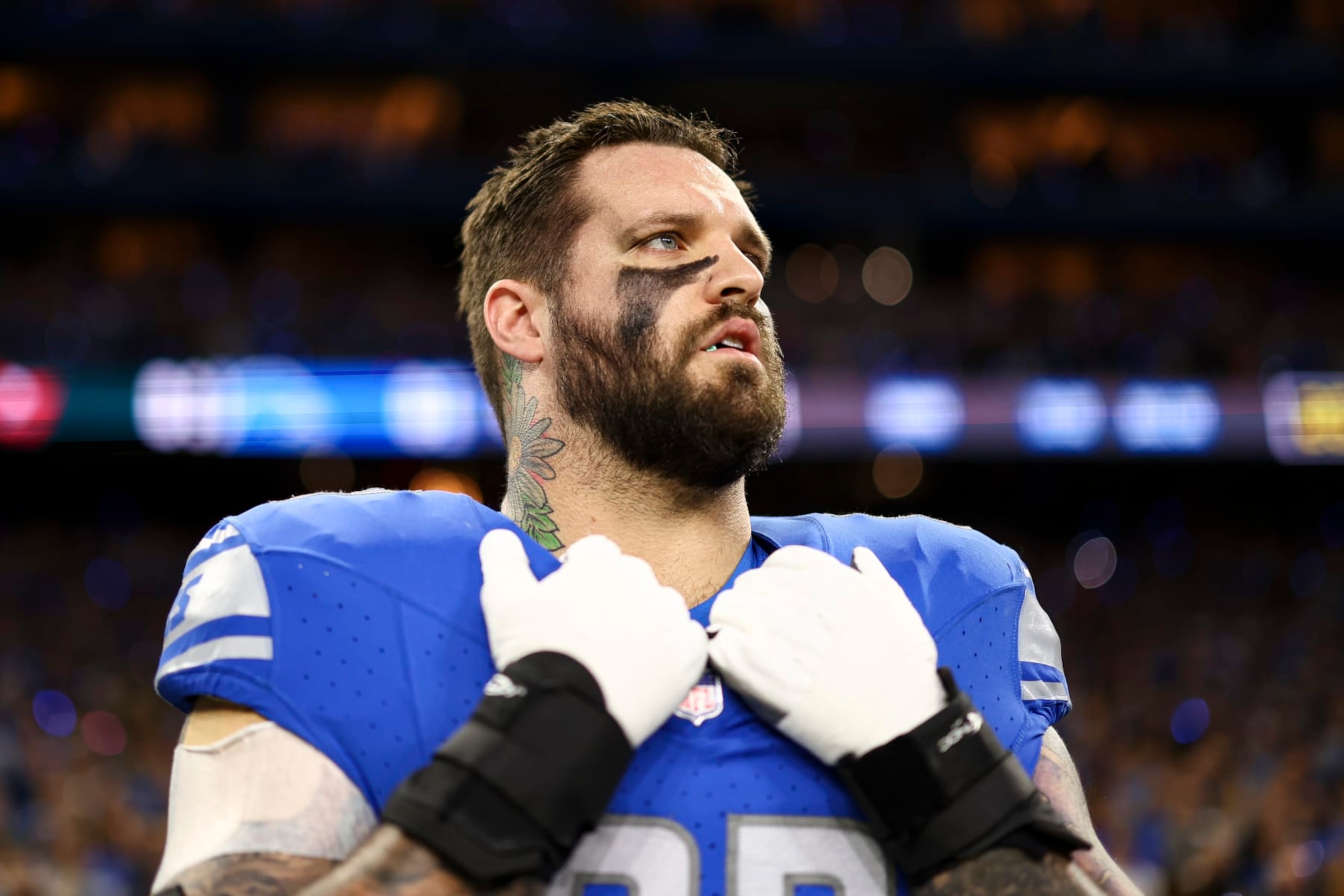 DETROIT, MI - JANUARY 21: Taylor Decker #68 of the Detroit Lions stands on the sidelines during the national anthem prior to an NFL divisional round playoff football game against the Tampa Bay Buccaneers at Ford Field on January 21, 2024 in Detroit, Michigan. (Photo by Kevin Sabitus/Getty Images)