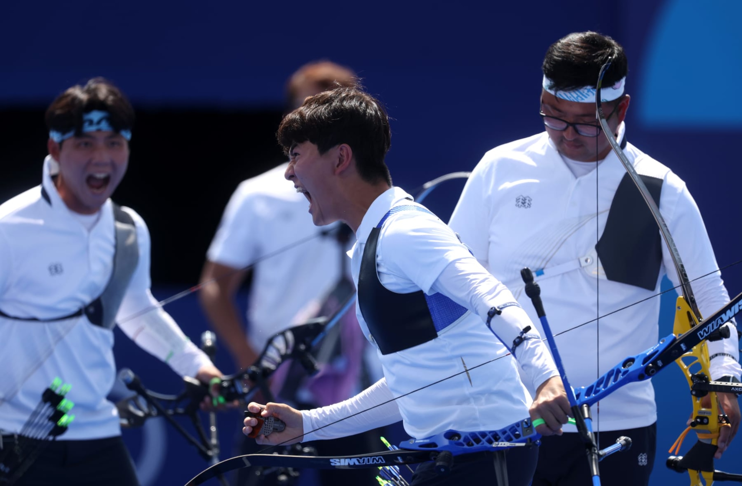 PARIS, FRANCE - JULY 29: Woojin Kim of Team Republic of Korea celebrates in the Archery Men's Team Quarterfinal against Team Japan on day three of the Olympic Games Paris 2024 at Esplanade Des Invalides on July 29, 2024 in Paris, France. (Photo by Julian Finney/Getty Images)