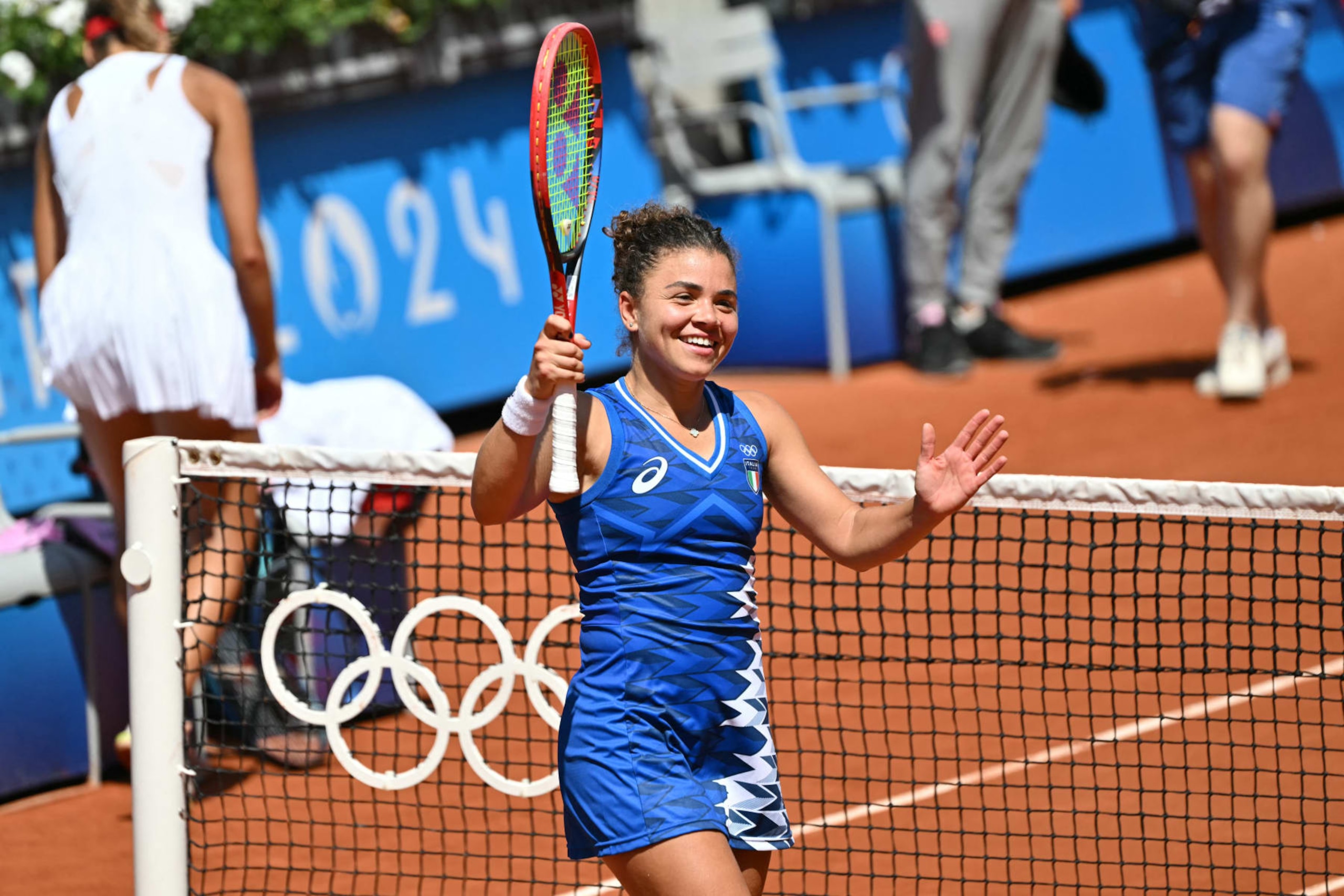 Italy's Jasmine Paolini celebrates after beating Poland's Magda Linette during their women's singles second round tennis match on Court Suzanne-Lenglen at the Roland-Garros Stadium at the Paris 2024 Olympic Games, in Paris on July 29, 2024. (Photo by Miguel MEDINA / AFP) (Photo by MIGUEL MEDINA/AFP via Getty Images)