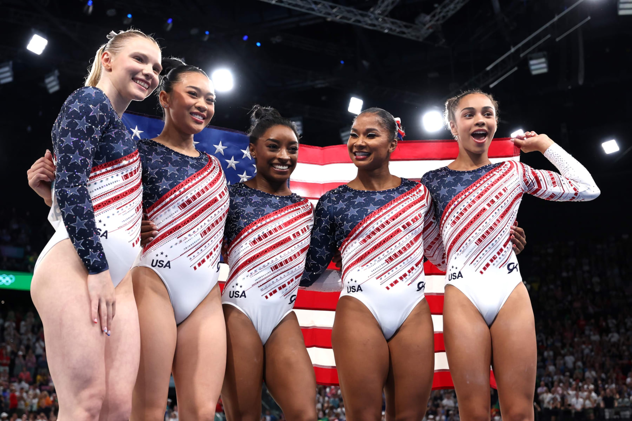 PARIS, FRANCE - JULY 30: (L-R) Jade Carey, Sunisa Lee, Simone Biles, Jordan Chiles and Hezly Rivera of Team United States celebrate during the Artistic Gymnastics Women's Team Final on day four of the Olympic Games Paris 2024 at Bercy Arena on July 30, 2024 in Paris, France. (Photo by Naomi Baker/Getty Images)