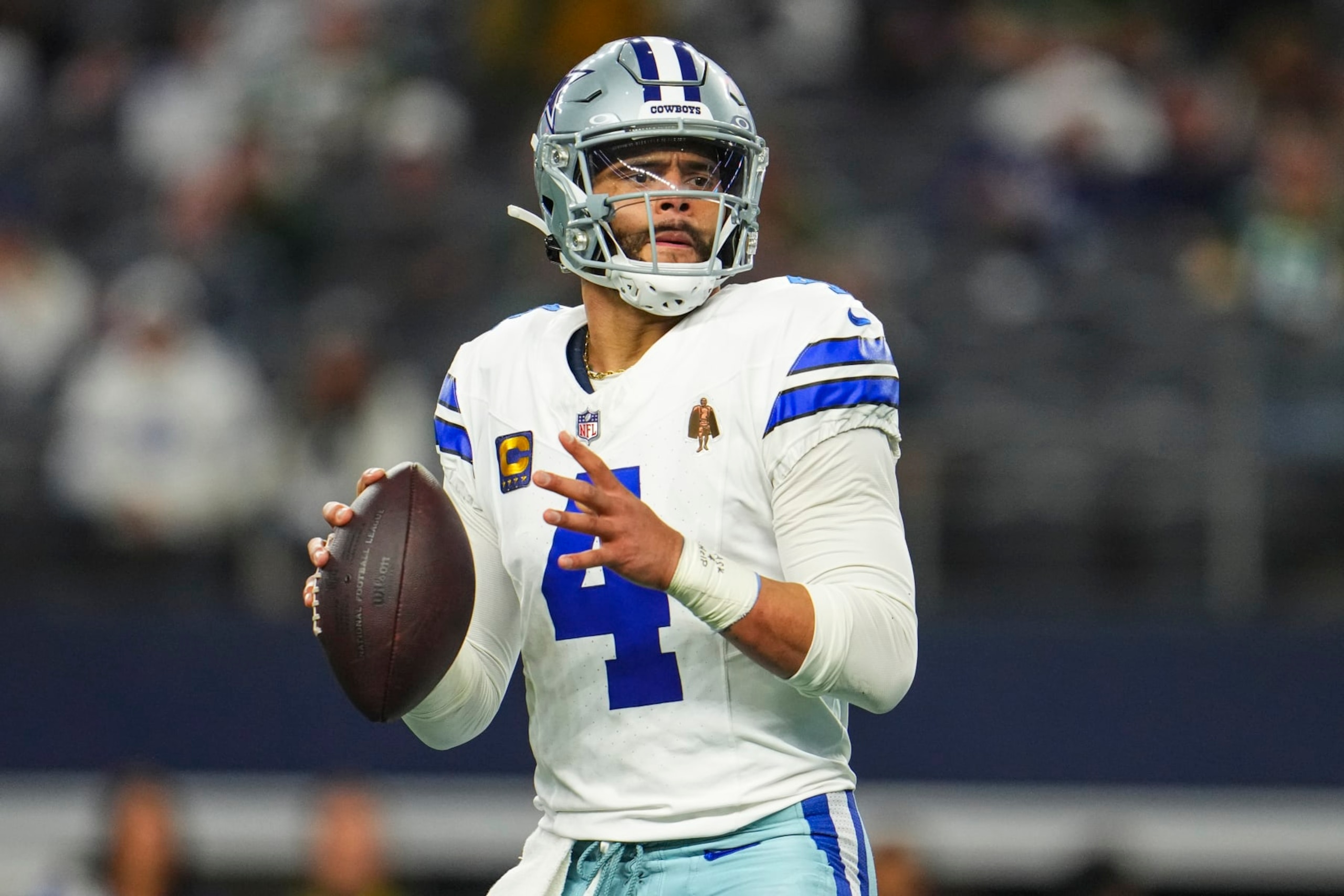 DALLAS, TX - JANUARY 14: Dak Prescott #4 of the Dallas Cowboys drops back to pass during an NFL wild-card playoff football game against the Green Bay Packers at AT&T Stadium on January 14, 2024 in Dallas, Texas. (Photo by Cooper Neill/Getty Images)