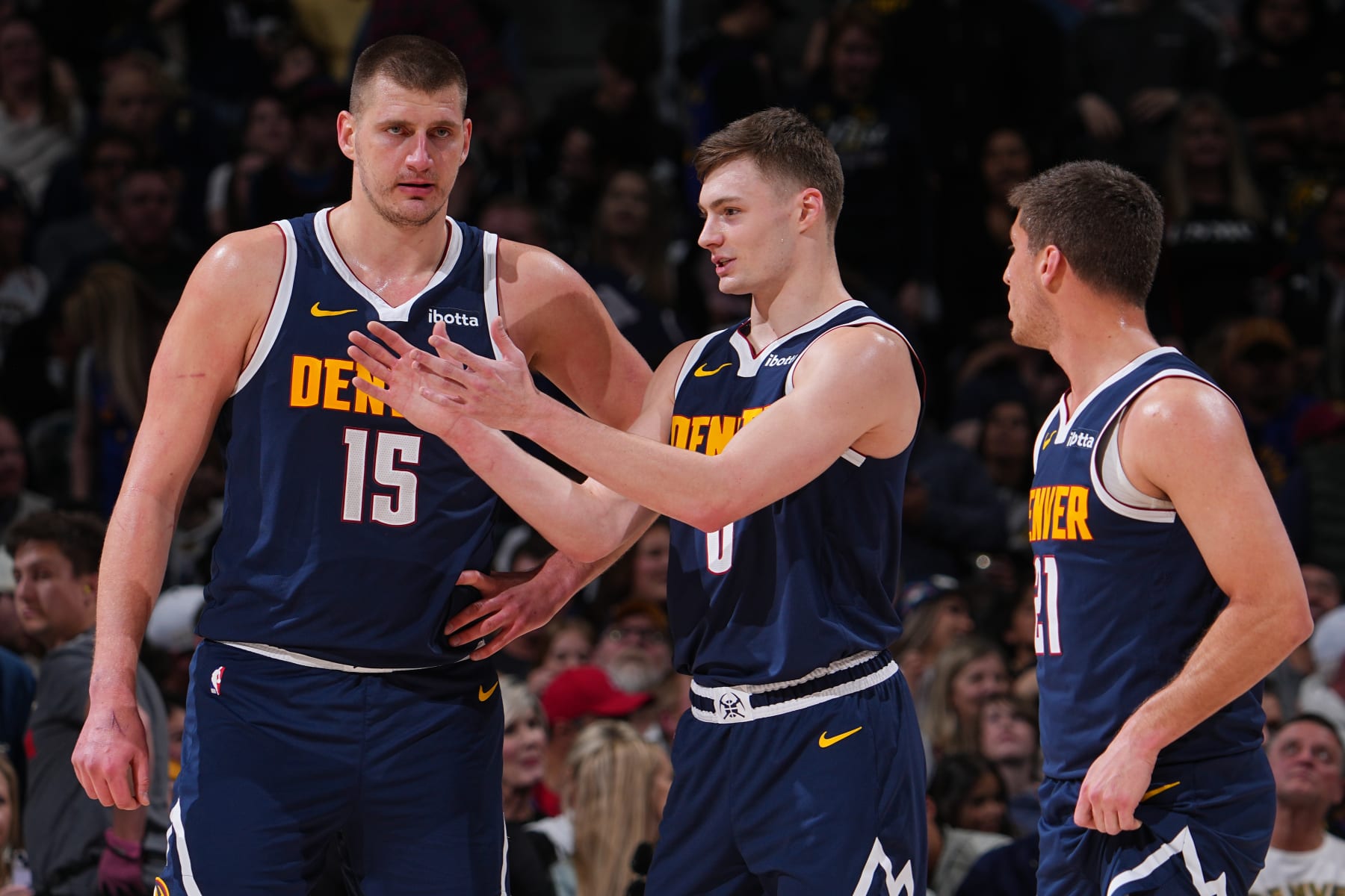 DENVER, CO - MARCH 25: Nikola Jokic #15, Christian Braun #0 talks to Collin Gillespie #21 of the Denver Nuggets during the game against the Memphis Grizzlies on March 25, 2024 at the Ball Arena in Denver, Colorado. NOTE TO USER: User expressly acknowledges and agrees that, by downloading and/or using this Photograph, user is consenting to the terms and conditions of the Getty Images License Agreement. Mandatory Copyright Notice: Copyright 2024 NBAE (Photo by Bart Young/NBAE via Getty Images)