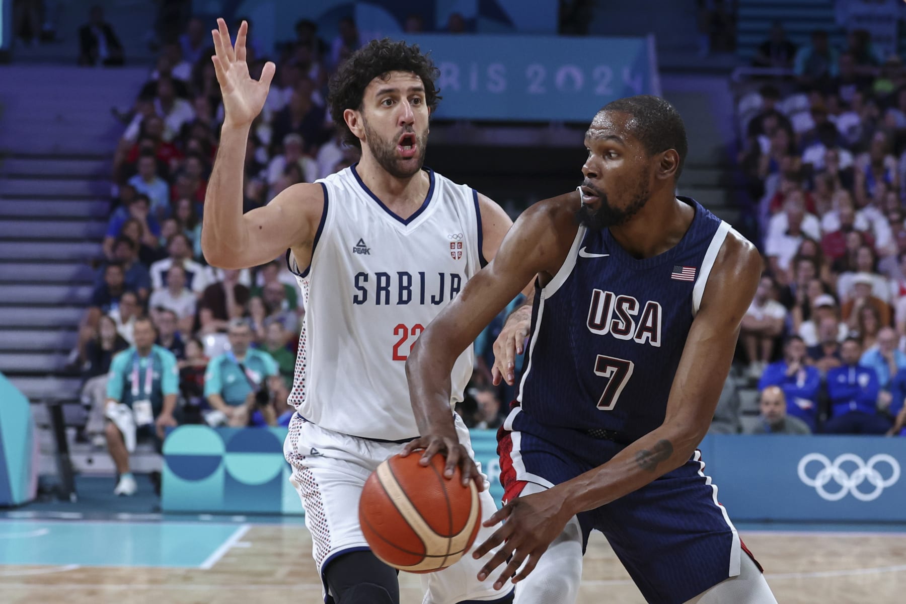 LILLE, FRANCE - JULY 28: Kevin Durant #7 of Team USA looks to pass the ball against Vasilije Micic #22 of Serbia during the Men's Group Phase - Group C match between Serbia and USA on Day 2 of the Olympic Games Paris 2024 at Stade Pierre Mauroy on July 28, 2024 in Lille, France. (Photo by Catherine Steenkeste/Getty Images)