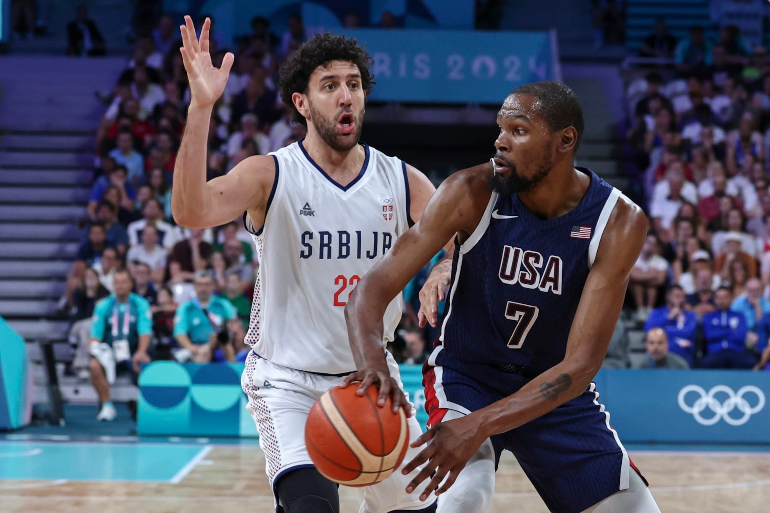 LILLE, FRANCE - JULY 28: Kevin Durant #7 of Team USA looks to pass the ball against Vasilije Micic #22 of Serbia during the Men's Group Phase - Group C match between Serbia and USA on Day 2 of the Olympic Games Paris 2024 at Stade Pierre Mauroy on July 28, 2024 in Lille, France. (Photo by Catherine Steenkeste/Getty Images) LILLE, FRANCE - JULY 28: Kevin Durant #7 of Team USA looks to pass the ball against Vasilije Micic #22 of Serbia during the Men's Group Phase - Group C match between Serbia and USA on Day 2 of the Olympic Games Paris 2024 at Stade Pierre Mauroy on July 28, 2024 in Lille, France. (Photo by Catherine Steenkeste/Getty Images)