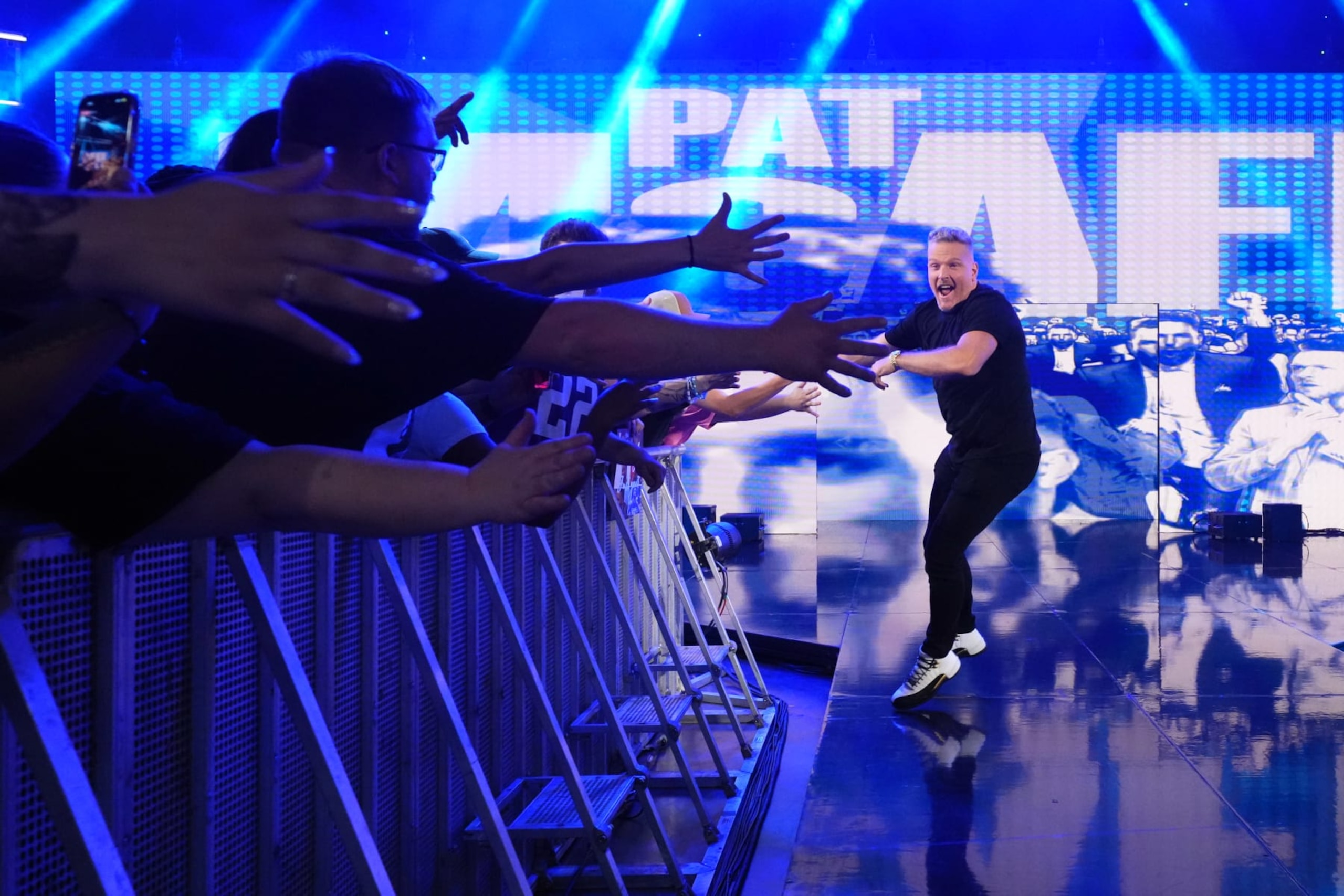 ST PAUL, MINNESOTA - JULY 29: Announcer Pat McAfee greets fans as he makes his entrance during WWE's Monday Night RAW at Xcel Energy Center on July 29, 2024 in St Paul, Minnesota.  (Photo by WWE/Getty Images)