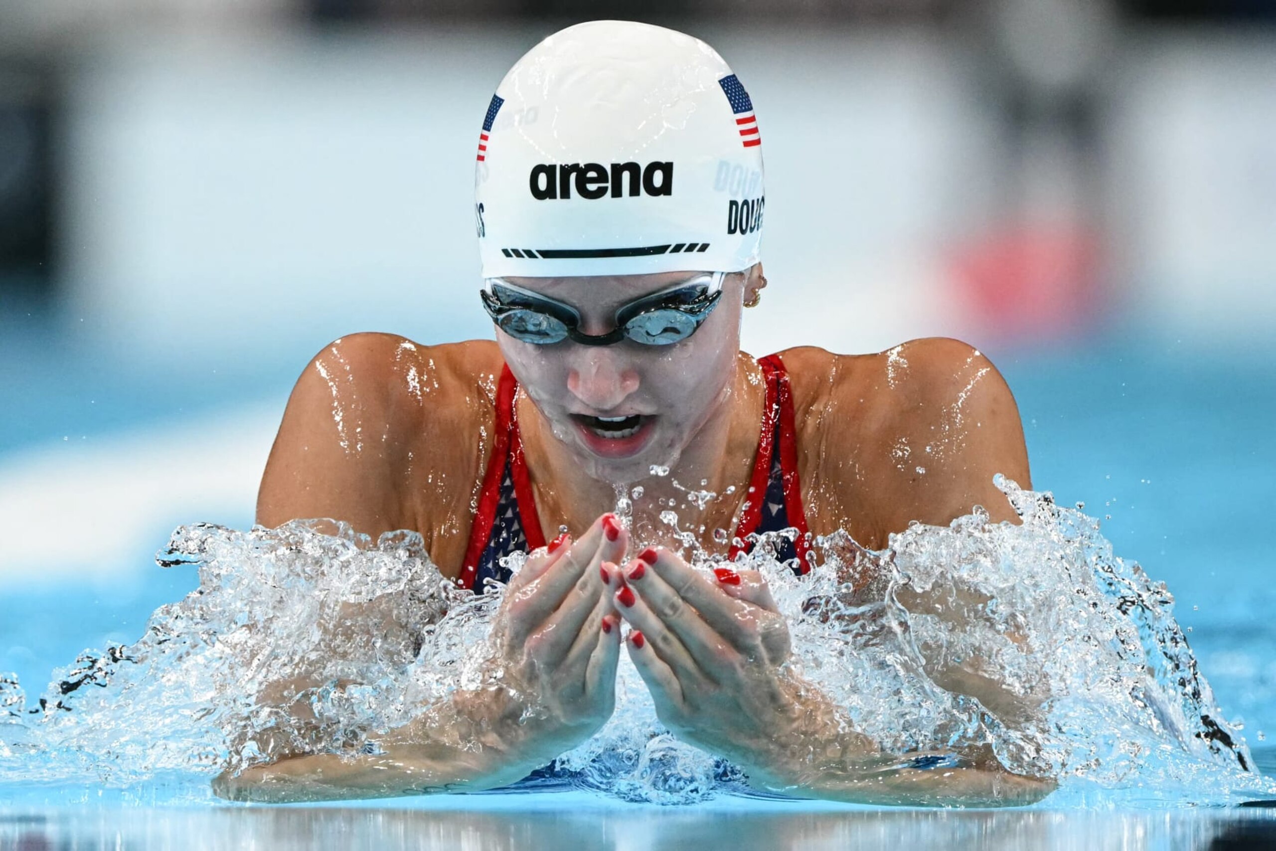 US' Kate Douglass competes in a heat of the women's 200m breaststroke swimming event during the Paris 2024 Olympic Games at the Paris La Defense Arena in Nanterre, west of Paris, on July 31, 2024. (Photo by Jonathan NACKSTRAND / AFP) (Photo by JONATHAN NACKSTRAND/AFP via Getty Images)
