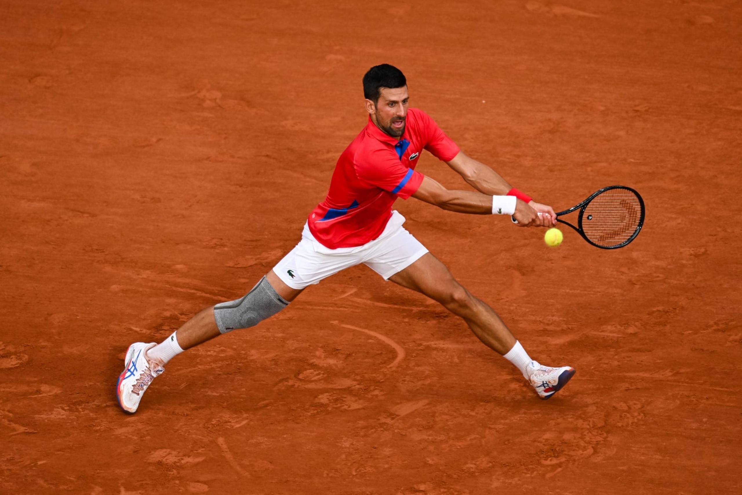 PARIS, FRANCE - AUGUST 01: Novak Djokovic of Serbia in action against Stefanos Tsitsipas of Greece in the Men's Singles Quarter Final match on day six of the Olympic Games Paris 2024 at Roland Garros on August 01, 2024 in Paris, France. (Photo by Daniel Kopatsch/Getty Images)