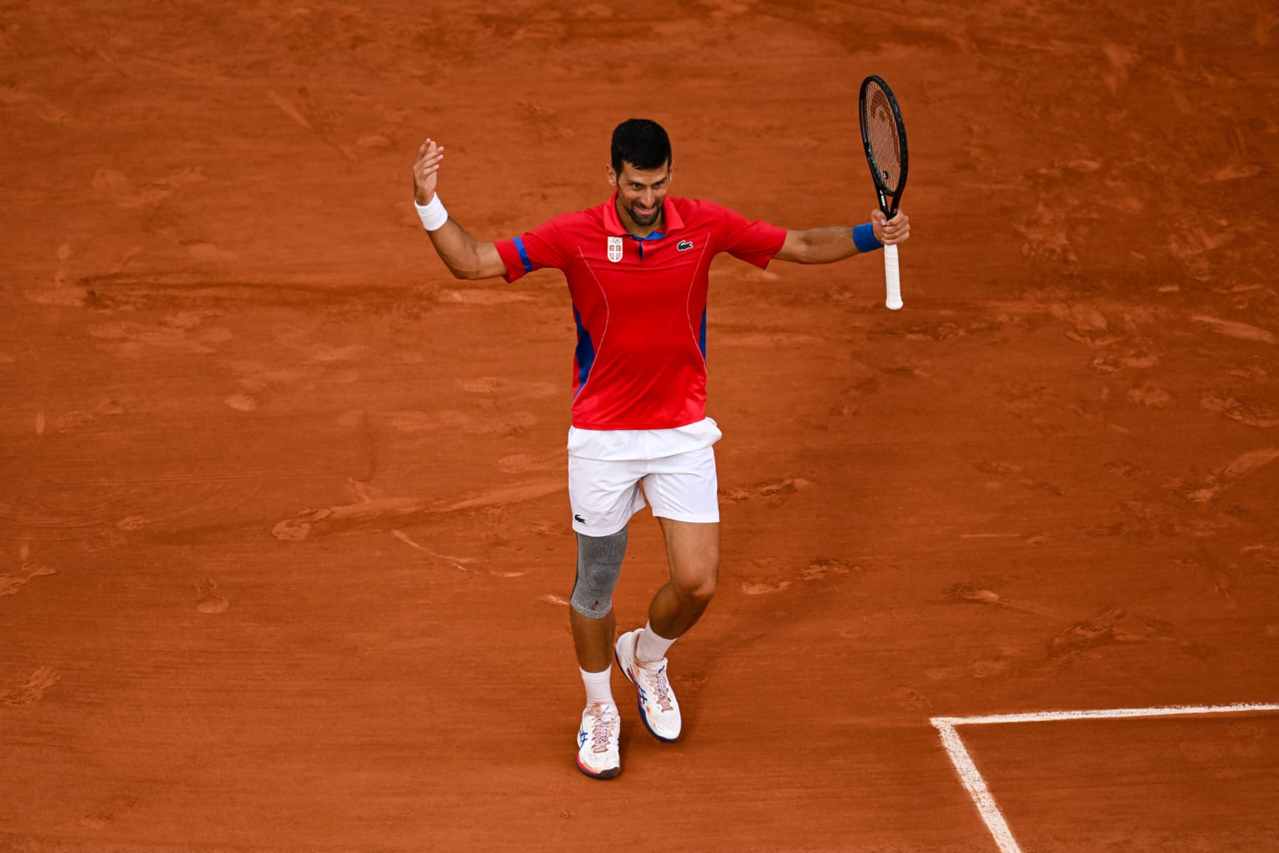PARIS, FRANCE - AUGUST 01: Novak Djokovic of Serbia reacts against Stefanos Tsitsipas of Greece in the Men's Singles Quarter Final match on day six of the Olympic Games Paris 2024 at Roland Garros on August 01, 2024 in Paris, France. (Photo by Daniel Kopatsch/Getty Images)