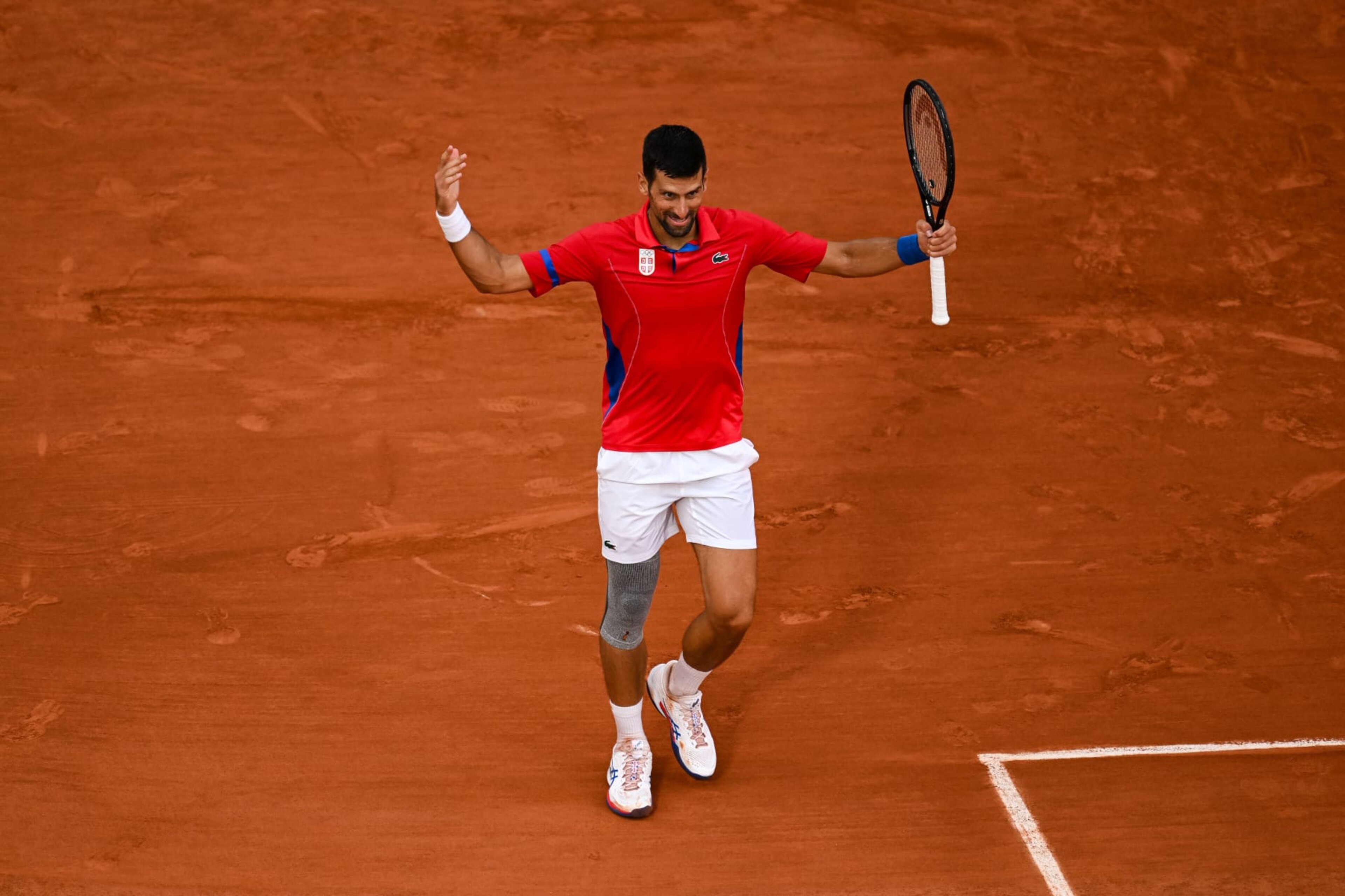 PARIS, FRANCE - AUGUST 01: Novak Djokovic of Serbia reacts against Stefanos Tsitsipas of Greece in the Men's Singles Quarter Final match on day six of the Olympic Games Paris 2024 at Roland Garros on August 01, 2024 in Paris, France. (Photo by Daniel Kopatsch/Getty Images)