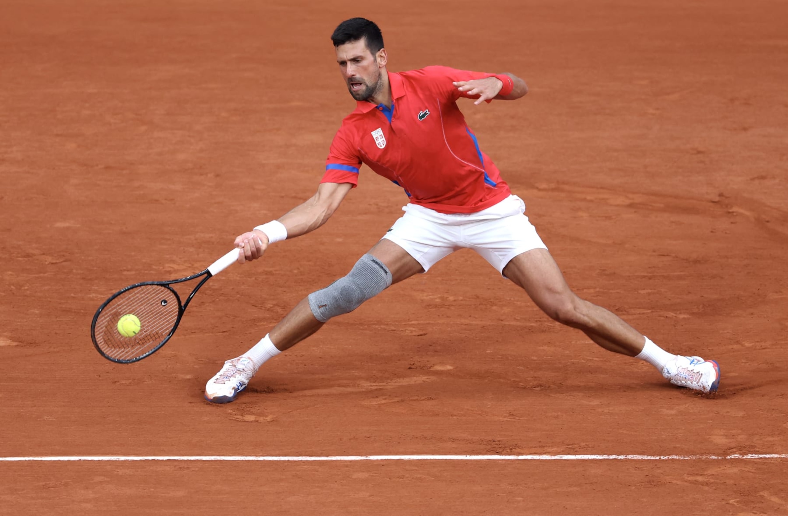 PARIS, FRANCE - AUGUST 01: Novak Djokovic of Team Serbia plays a forehand against Stefanos Tsitsipas of Team Greece during the Men's Singles Quarter-final match on day six of the Olympic Games Paris 2024 at Roland Garros on August 01, 2024 in Paris, France. (Photo by Matthew Stockman/Getty Images) PARIS, FRANCE - AUGUST 01: Novak Djokovic of Team Serbia plays a forehand against Stefanos Tsitsipas of Team Greece during the Men's Singles Quarter-final match on day six of the Olympic Games Paris 2024 at Roland Garros on August 01, 2024 in Paris, France. (Photo by Matthew Stockman/Getty Images)