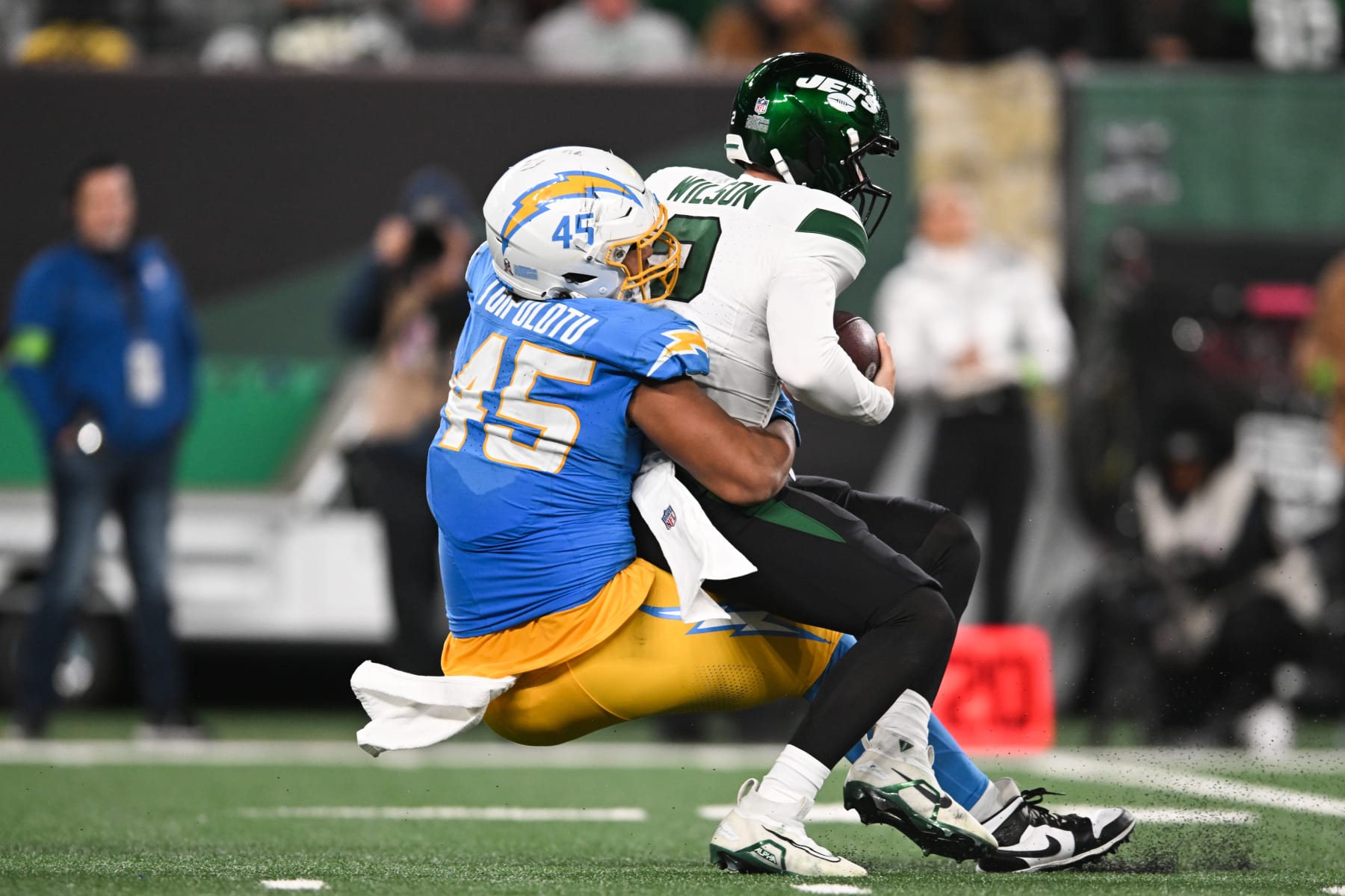 EAST RUTHERFORD, NJ - NOVEMBER 06: Tuli Tuipulotu #45 of the Los Angeles Chargers sacks Zach Wilson #2 of the New York Jets during the second half at MetLife Stadium on November 6, 2023 in East Rutherford, New Jersey. (Photo by Kathryn Riley/Getty Images)