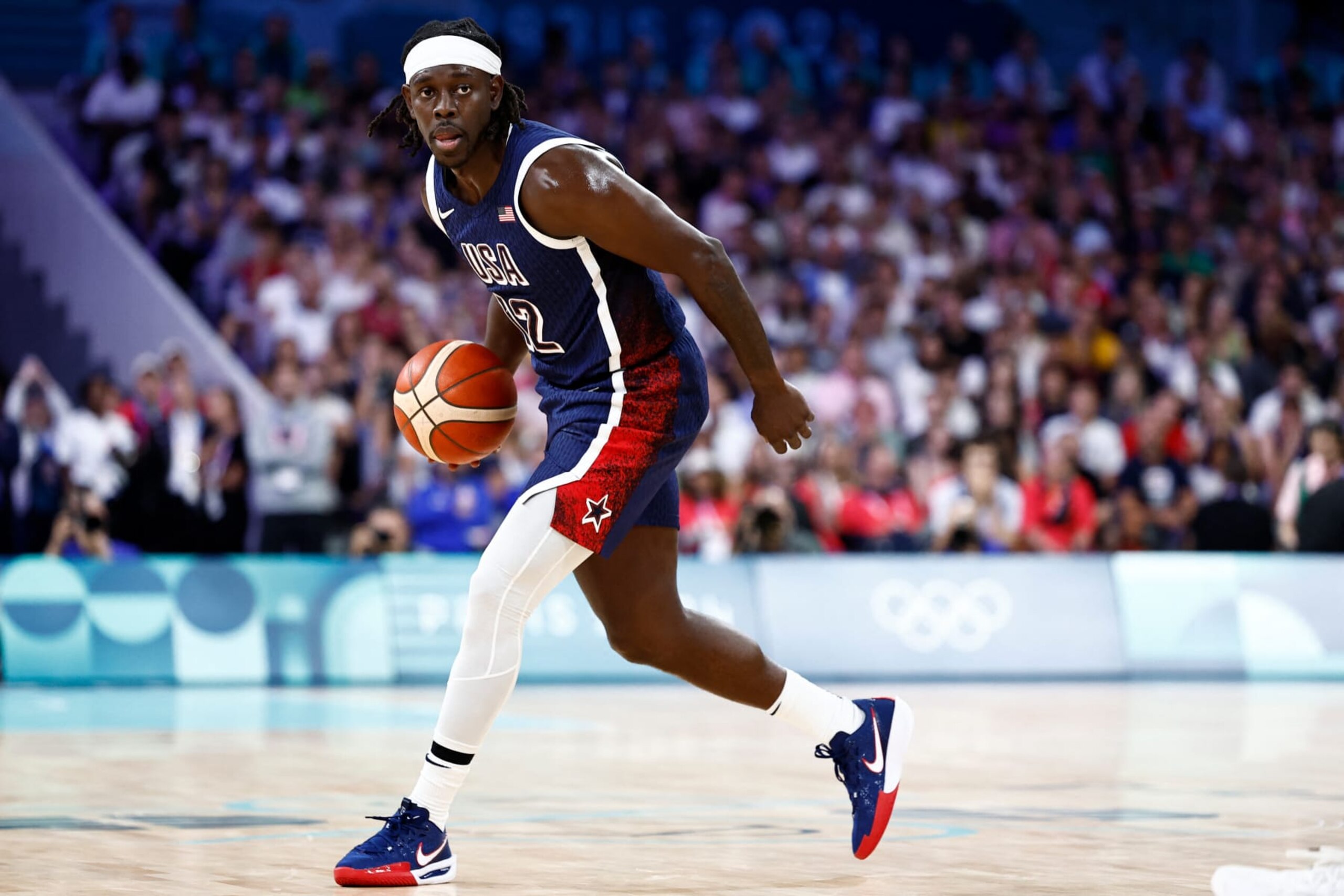 USA's #12 Jrue Holiday dribbles the ball in the men's preliminary round group C basketball match between Serbia and USA during the Paris 2024 Olympic Games at the Pierre-Mauroy stadium in Villeneuve-d'Ascq, northern France, on July 28, 2024. (Photo by Sameer Al-Doumy / AFP) (Photo by SAMEER AL-DOUMY/AFP via Getty Images)