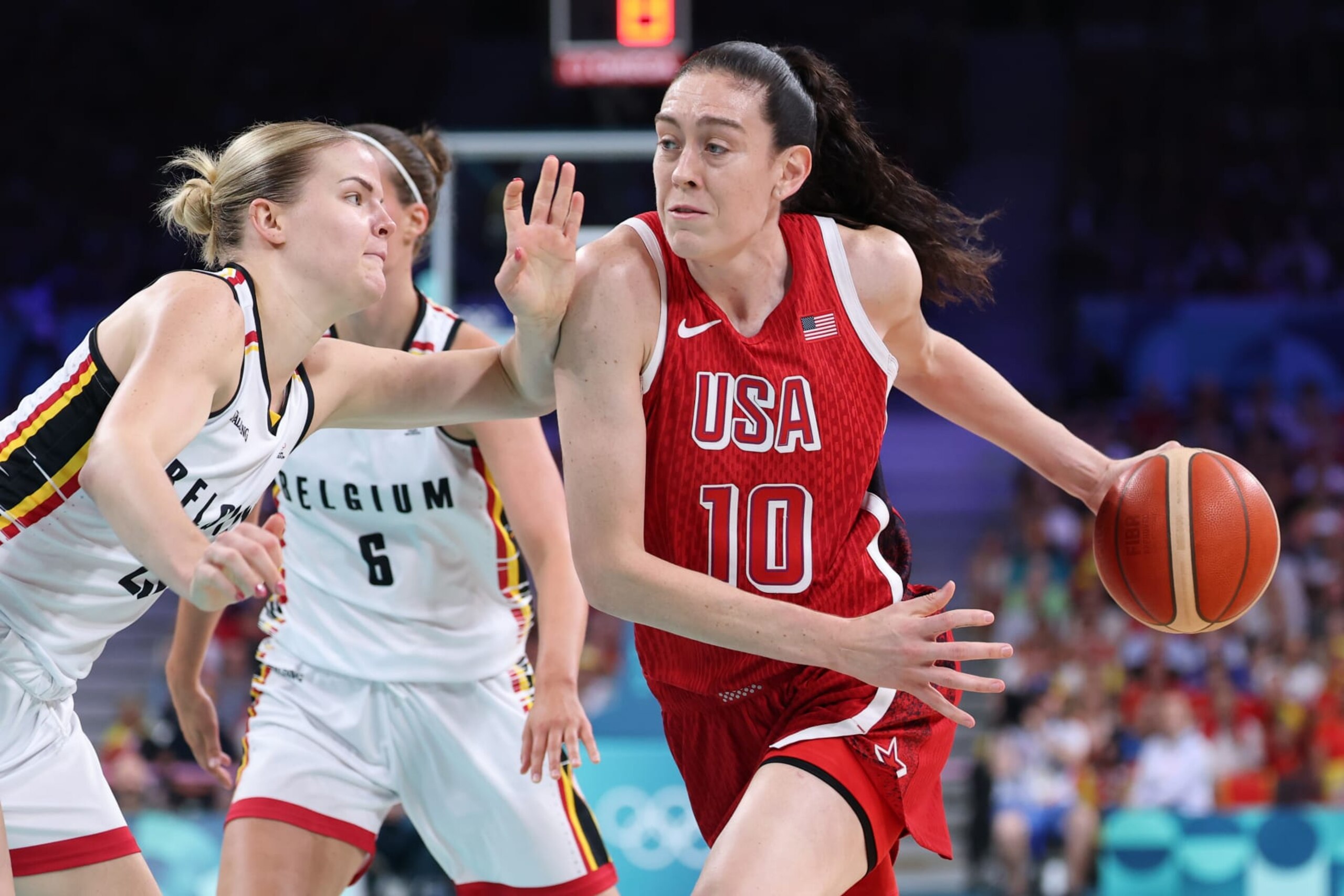 LILLE, FRANCE - AUGUST 01: Breanna Stewart #10 of Team United States drives past Becky Massey #25 of Team Belgium during a Women's Basketball Group Phase - Group C game between the United States and Belgium on day six of the Olympic Games Paris 2024 at Stade Pierre Mauroy on August 01, 2024 in Lille, France. (Photo by Gregory Shamus/Getty Images) LILLE, FRANCE - AUGUST 01: Breanna Stewart #10 of Team United States drives past Becky Massey #25 of Team Belgium during a Women's Basketball Group Phase - Group C game between the United States and Belgium on day six of the Olympic Games Paris 2024 at Stade Pierre Mauroy on August 01, 2024 in Lille, France. (Photo by Gregory Shamus/Getty Images)
