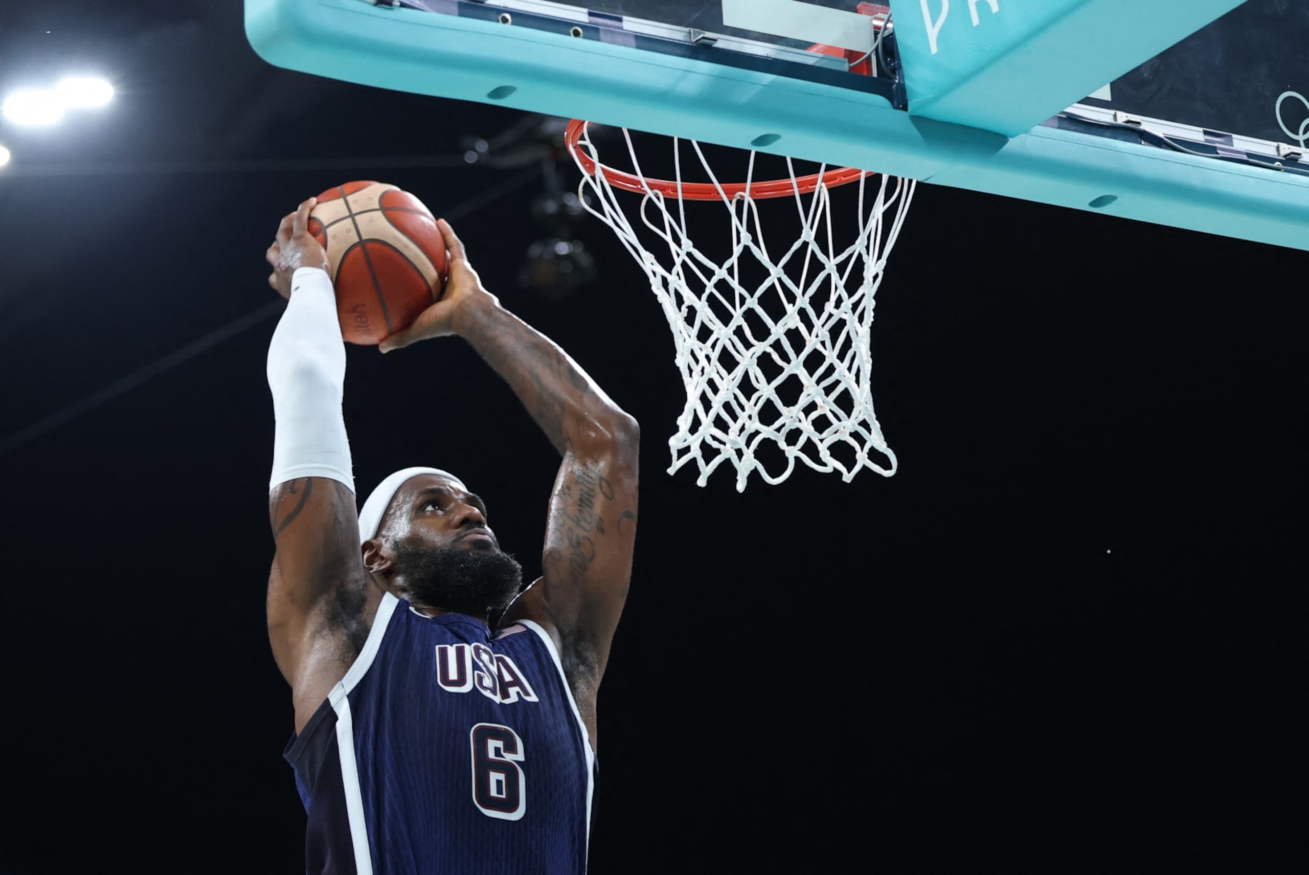 USA's #06 LeBron James dunks the ball in the men's preliminary round group C basketball match between Puerto Rico and USA during the Paris 2024 Olympic Games at the Pierre-Mauroy stadium in Villeneuve-d'Ascq, northern France, on August 3, 2024. (Photo by Thomas COEX / AFP) (Photo by THOMAS COEX/AFP via Getty Images)