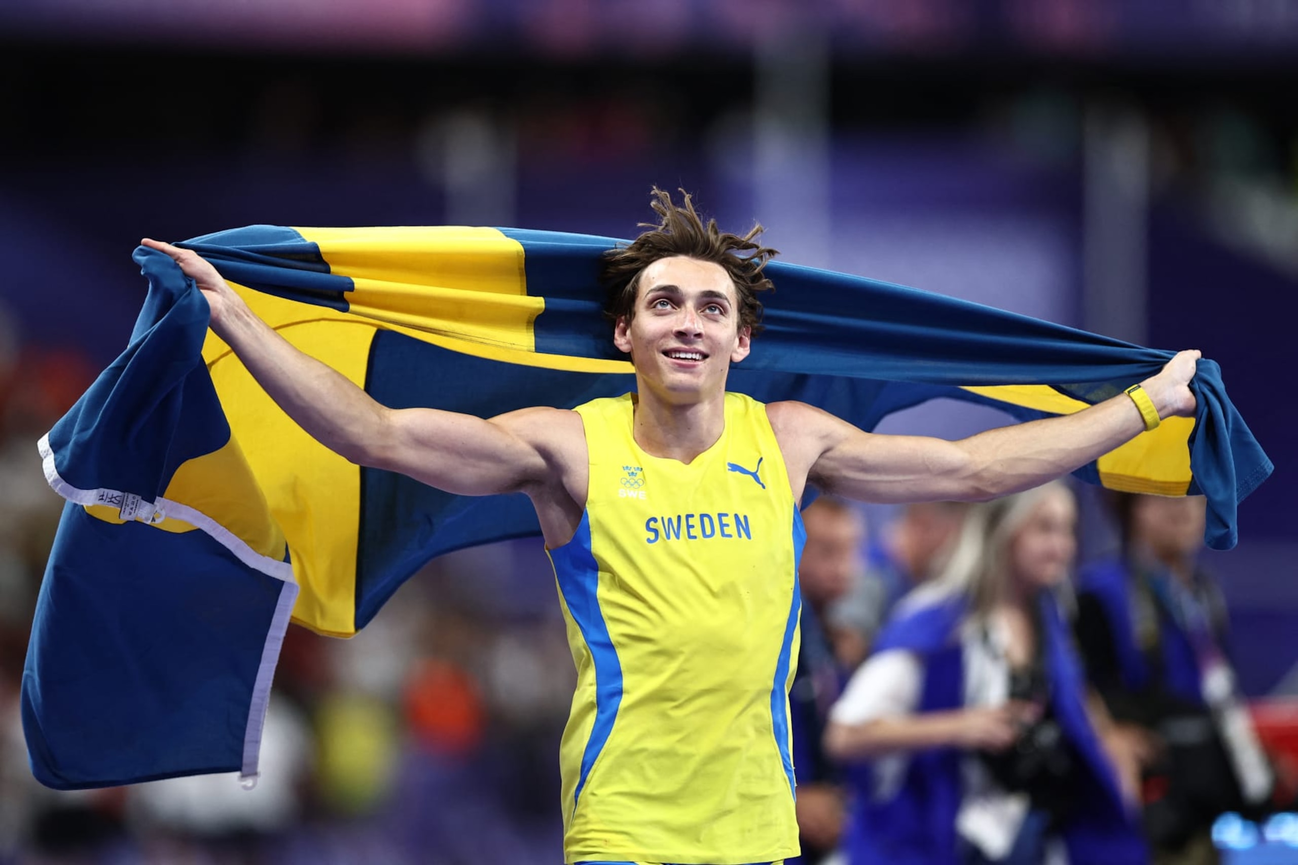 Sweden's Armand Duplantis celebrates after setting a new world record in the men's pole vault final of the athletics event at the Paris 2024 Olympic Games at Stade de France in Saint-Denis, north of Paris, on August 5, 2024. (Photo by Anne-Christine POUJOULAT / AFP) (Photo by ANNE-CHRISTINE POUJOULAT/AFP via Getty Images)