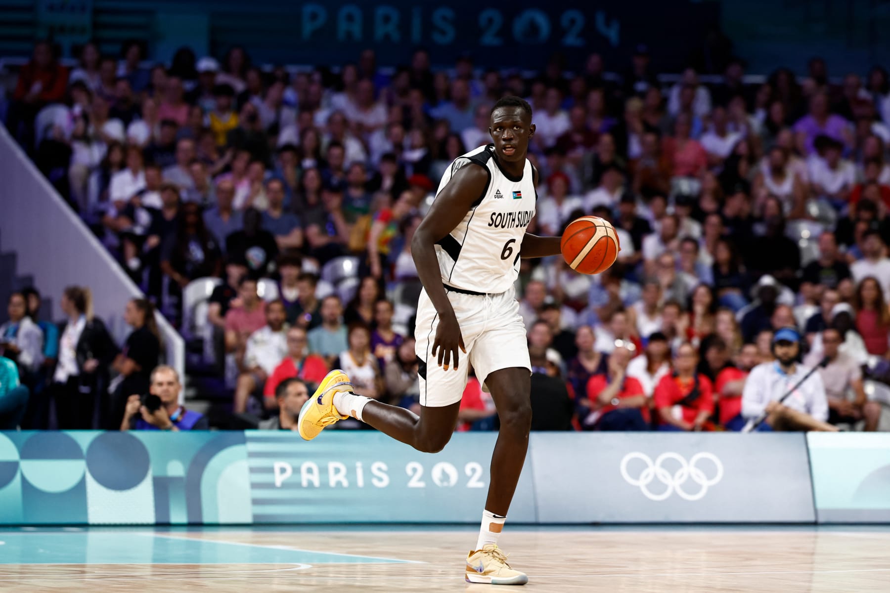 South Sudan's #06 Khaman Maluach dribbles the ball in the men's preliminary round group C basketball match between South Sudan and Puerto Rico during the Paris 2024 Olympic Games at the Pierre-Mauroy stadium in Villeneuve-d'Ascq, northern France, on July 28, 2024. (Photo by Sameer Al-Doumy / AFP) (Photo by SAMEER AL-DOUMY/AFP via Getty Images)