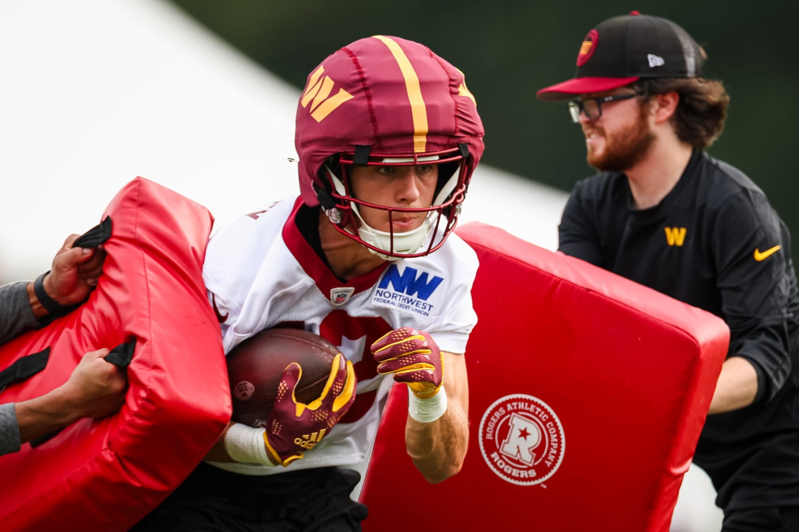 ASHBURN, VA - JULY 25: Luke McCaffrey #12 of the Washington Commanders participates in a drill during training camp at OrthoVirginia Training Center at Commanders Park on July 25, 2024 in Ashburn, Virginia. (Photo by Scott Taetsch/Getty Images)