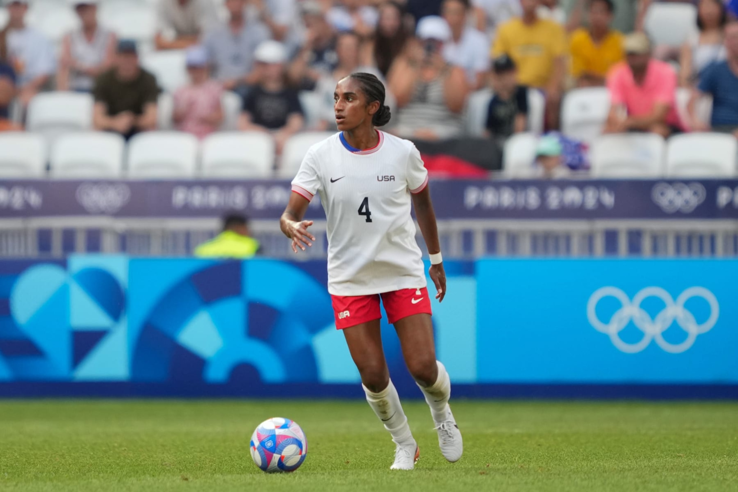 LYON, FRANCE - AUGUST 06: Naomi Girma #4 of the United States  on the ball during the first half against Germany during the Women's semifinal match during the Olympic Games Paris 2024 at Stade de Lyon on August 06, 2024 in Lyon, France. (Photo by John Todd/ISI/Getty Images)