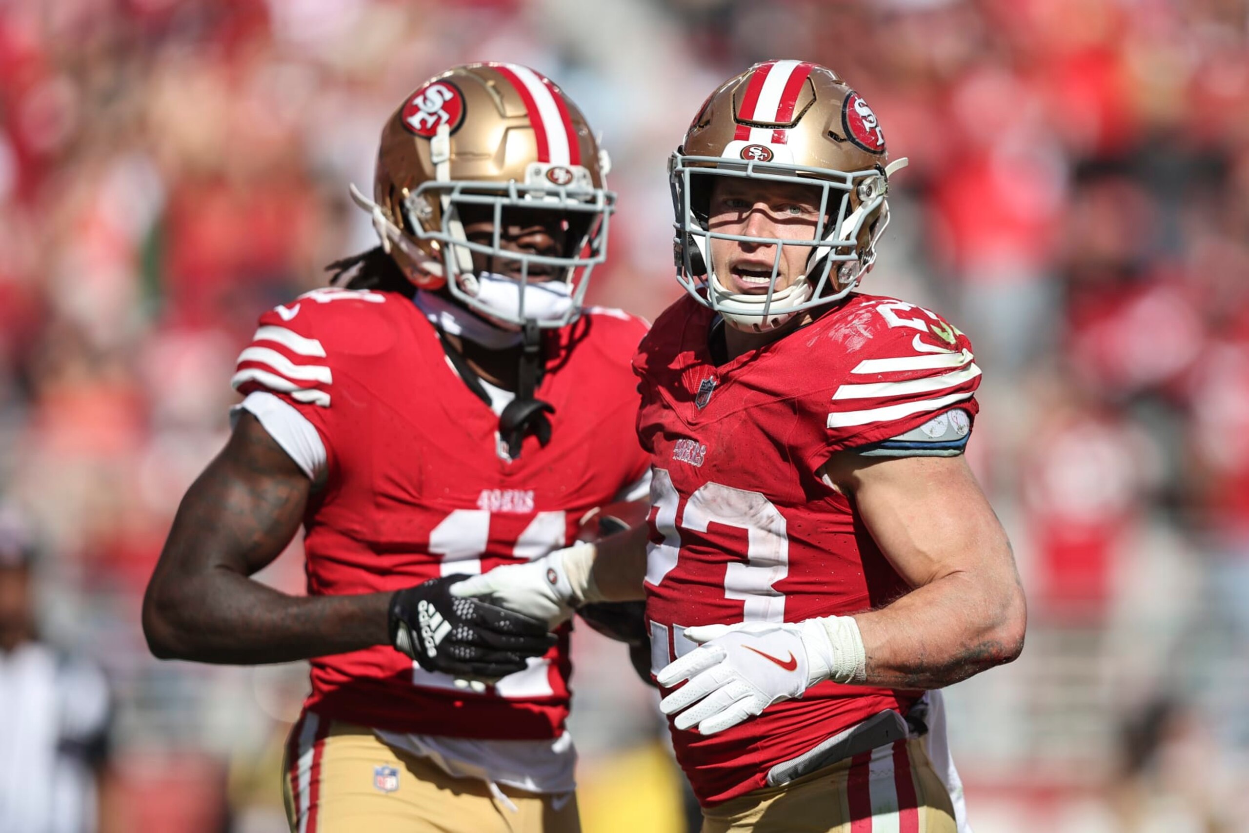 SANTA CLARA, CALIFORNIA - OCTOBER 01: Christian McCaffrey #23 of the San Francisco 49ers celebrates with his teammate Brandon Aiyuk #11 of the San Francisco 49ers after scoring a touchdown during an NFL football game between the San Francisco 49ers and the Arizona Cardinals at Levi's Stadium on October 01, 2023 in Santa Clara, California. (Photo by Michael Owens/Getty Images)