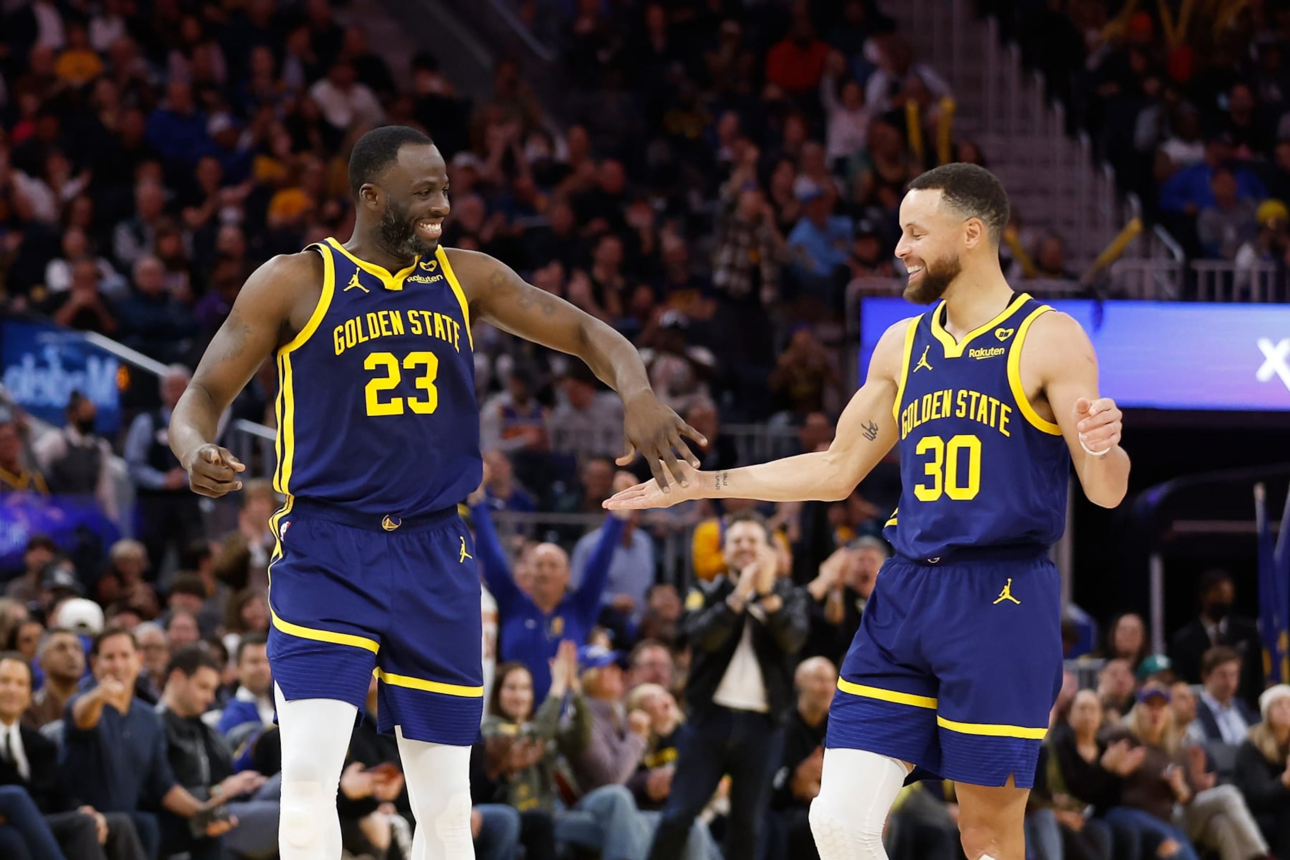 SAN FRANCISCO, CALIFORNIA - FEBRUARY 22: Draymond Green #23 and Stephen Curry #30 of the Golden State Warriors react after a play in the second half against the Los Angeles Lakers at Chase Center on February 22, 2024 in San Francisco, California. NOTE TO USER: User expressly acknowledges and agrees that, by downloading and or using this photograph, User is consenting to the terms and conditions of the Getty Images License Agreement. (Photo by Lachlan Cunningham/Getty Images)