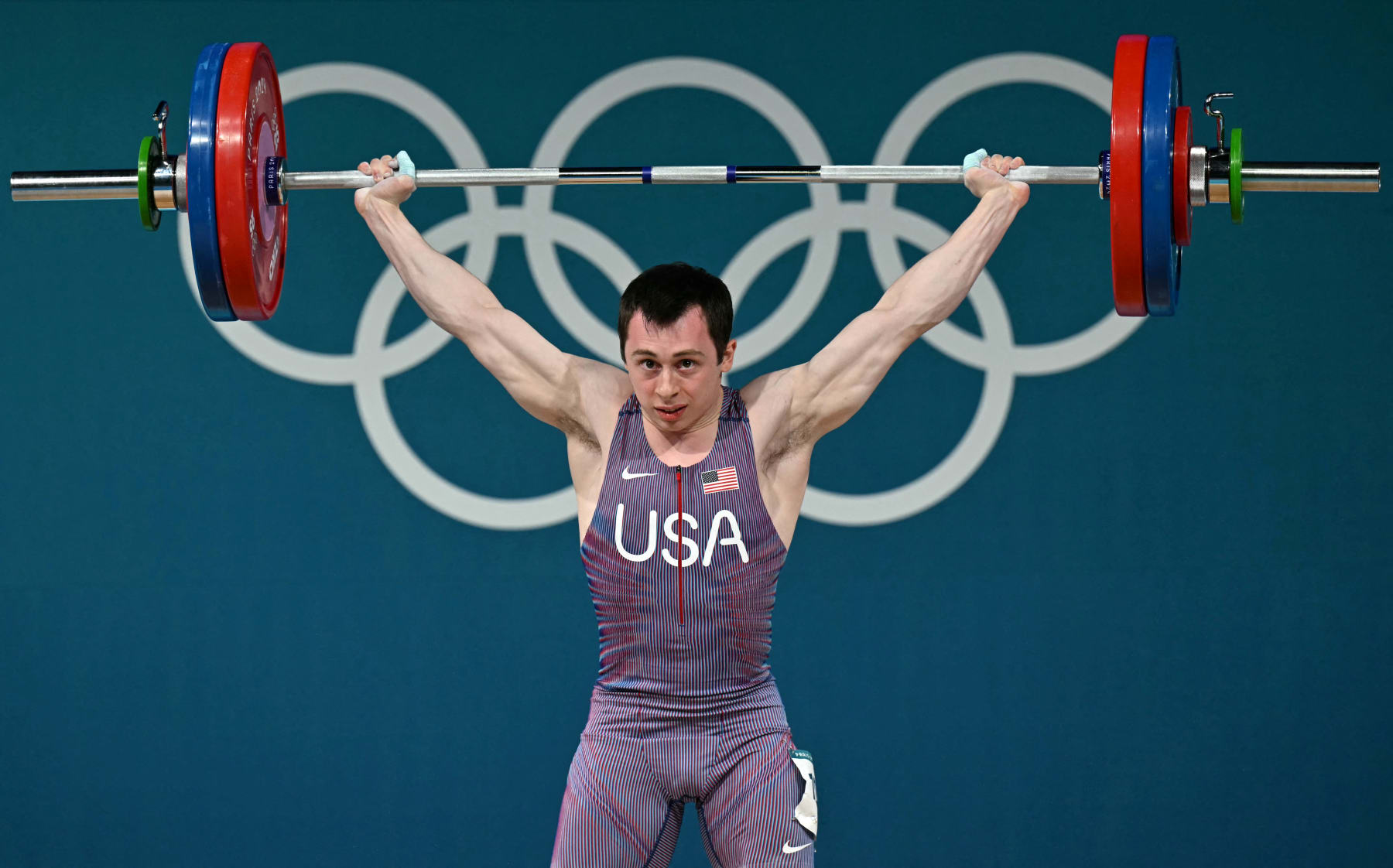 US' Hampton Morris competes in the men's -61kg weightlifting event during the Paris 2024 Olympic Games at the South Paris Arena in Paris, on August 7, 2024. (Photo by Miguel MEDINA / AFP) (Photo by MIGUEL MEDINA/AFP via Getty Images)