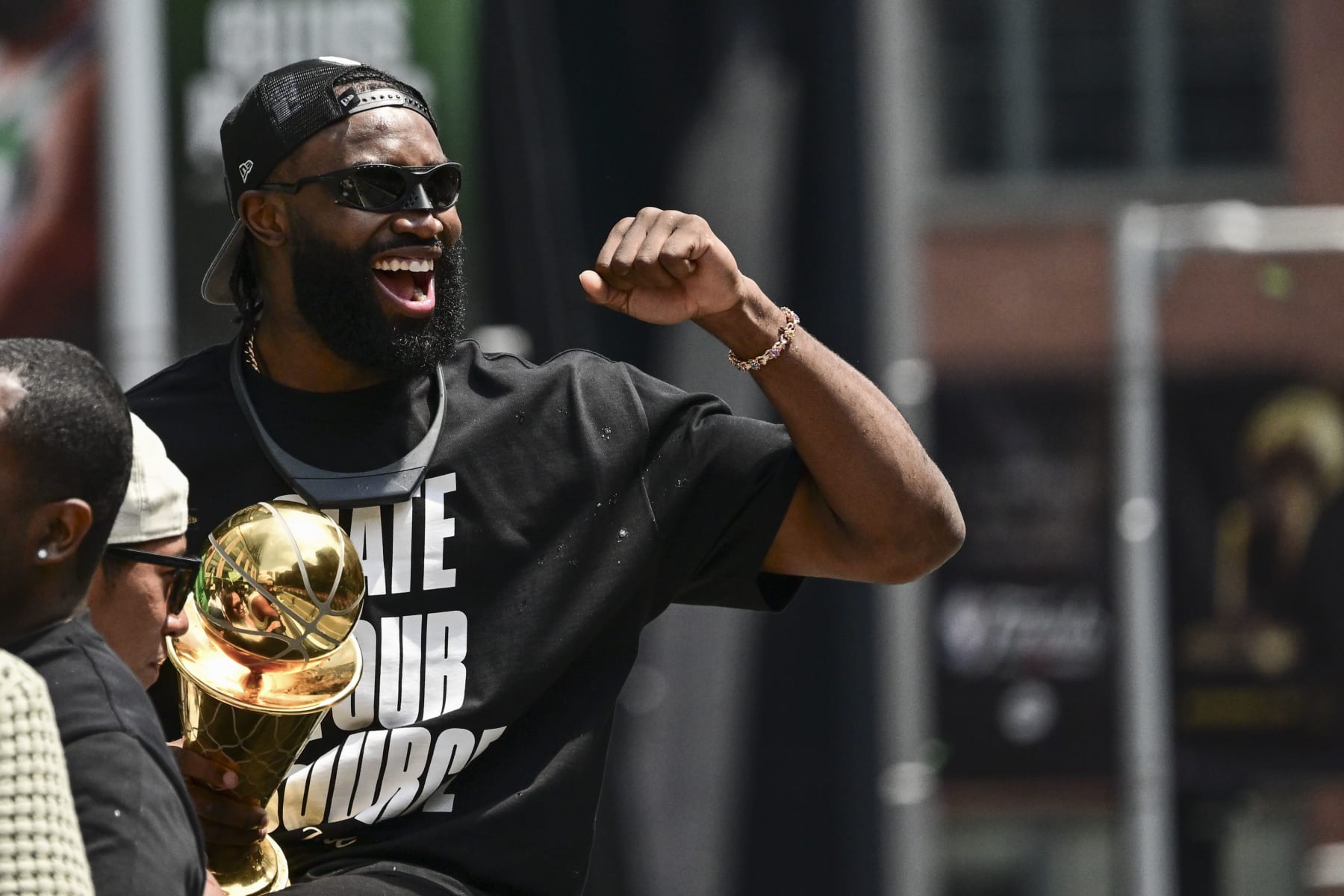 BOSTON, MASSACHUSETTS - JUNE 21: Jaylen Brown #7 of the Boston Celtics reacts as he holds the NBA Finals Most Valuable Player trophy during the 2024 Boston Celtics championship parade following their 2024 NBA Finals win on June 21, 2024 in Boston, Massachusetts.  (Photo by Billie Weiss/Getty Images)