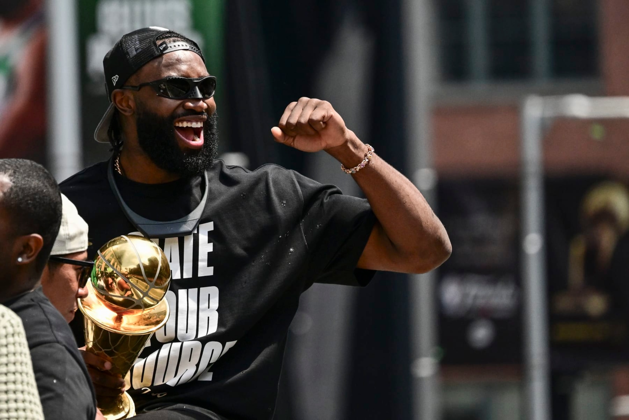 BOSTON, MASSACHUSETTS - JUNE 21: Jaylen Brown #7 of the Boston Celtics reacts as he holds the NBA Finals Most Valuable Player trophy during the 2024 Boston Celtics championship parade following their 2024 NBA Finals win on June 21, 2024 in Boston, Massachusetts.  (Photo by Billie Weiss/Getty Images)