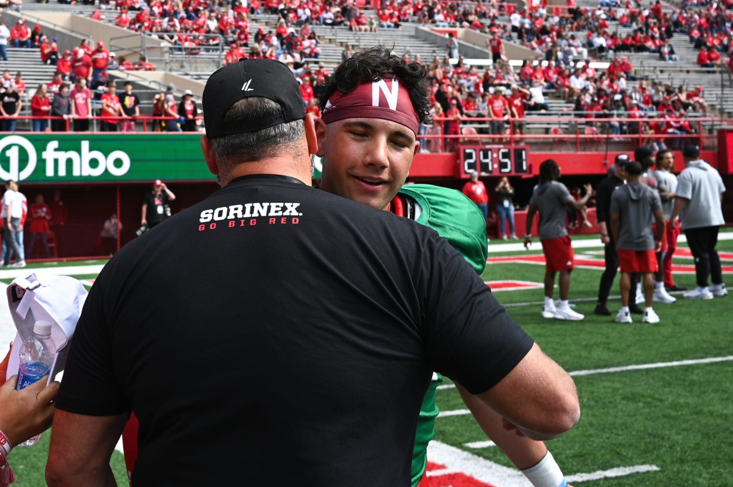 LINCOLN, NEBRASKA - APRIL 27: Dylan Raiola #15 of the Nebraska Cornhuskers greets his father, former player Dominic Raiola, at the Nebraska Spring Football Game at Memorial Stadium on April 27, 2024 in Lincoln, Nebraska. (Photo by Steven Branscombe/Getty Images)