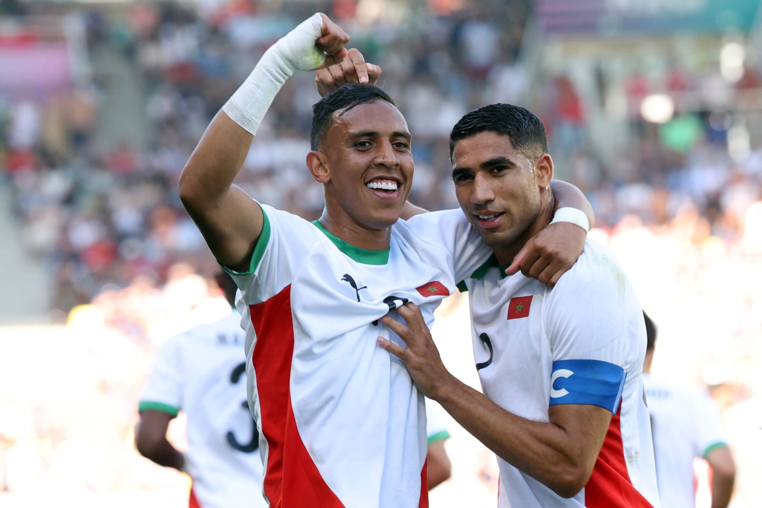 (From L) Morocco's forward #09 Soufiane Rahimi celebrates scoring the opening goal with Morocco's defender #02 Achraf Hakimi in the men's bronze medal football match between Egypt and Morocco during the Paris 2024 Olympic Games at the La Beaujoire Stadium in Nantes on August 8, 2024. (Photo by ALAIN JOCARD / AFP) (Photo by ALAIN JOCARD/AFP via Getty Images)