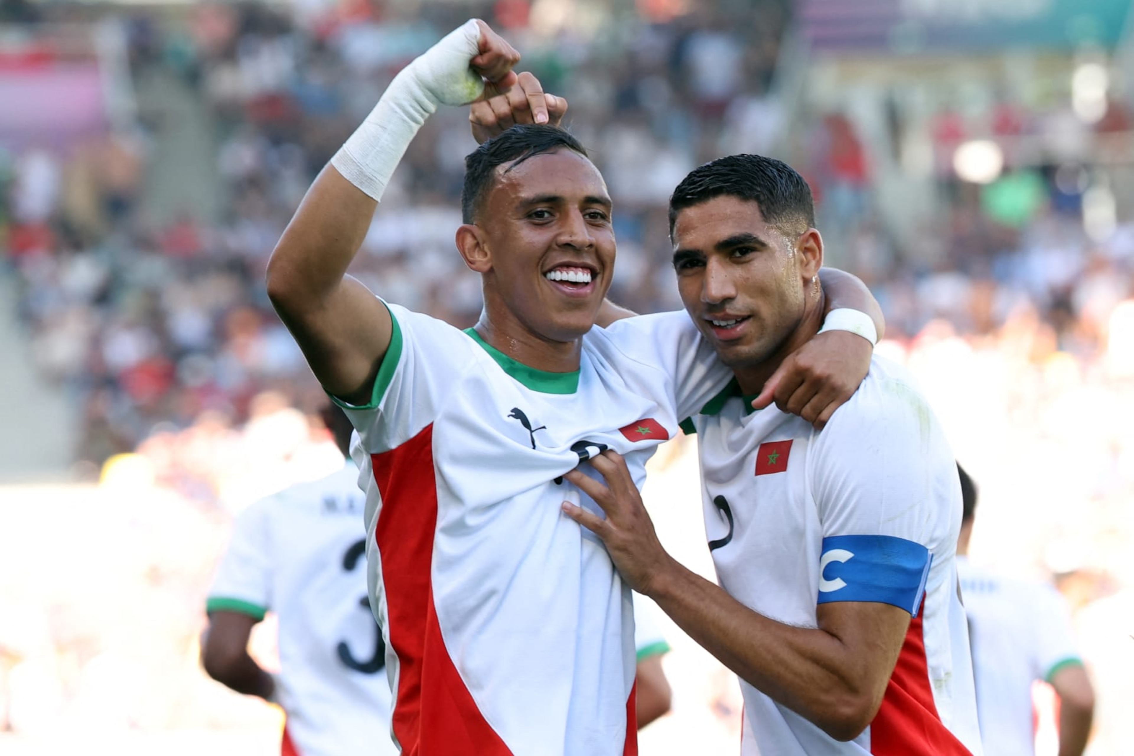 (From L) Morocco's forward #09 Soufiane Rahimi celebrates scoring the opening goal with Morocco's defender #02 Achraf Hakimi in the men's bronze medal football match between Egypt and Morocco during the Paris 2024 Olympic Games at the La Beaujoire Stadium in Nantes on August 8, 2024. (Photo by ALAIN JOCARD / AFP) (Photo by ALAIN JOCARD/AFP via Getty Images)