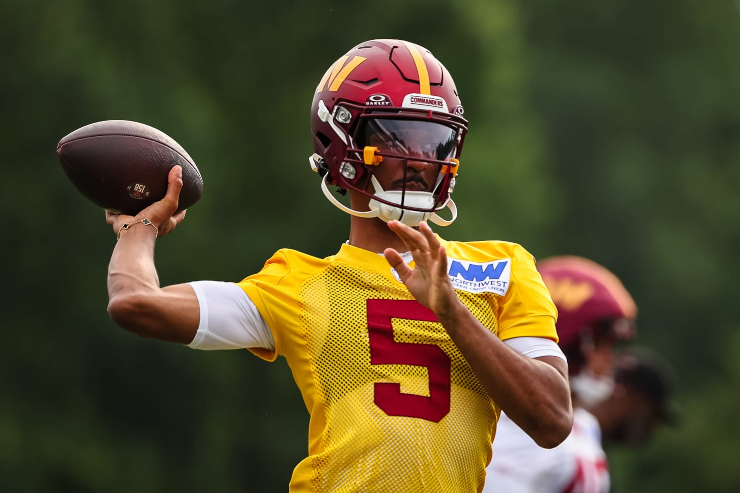 ASHBURN, VA - JULY 25: Jayden Daniels #5 of the Washington Commanders attempts a pass during training camp at OrthoVirginia Training Center at Commanders Park on July 25, 2024 in Ashburn, Virginia. (Photo by Scott Taetsch/Getty Images)
