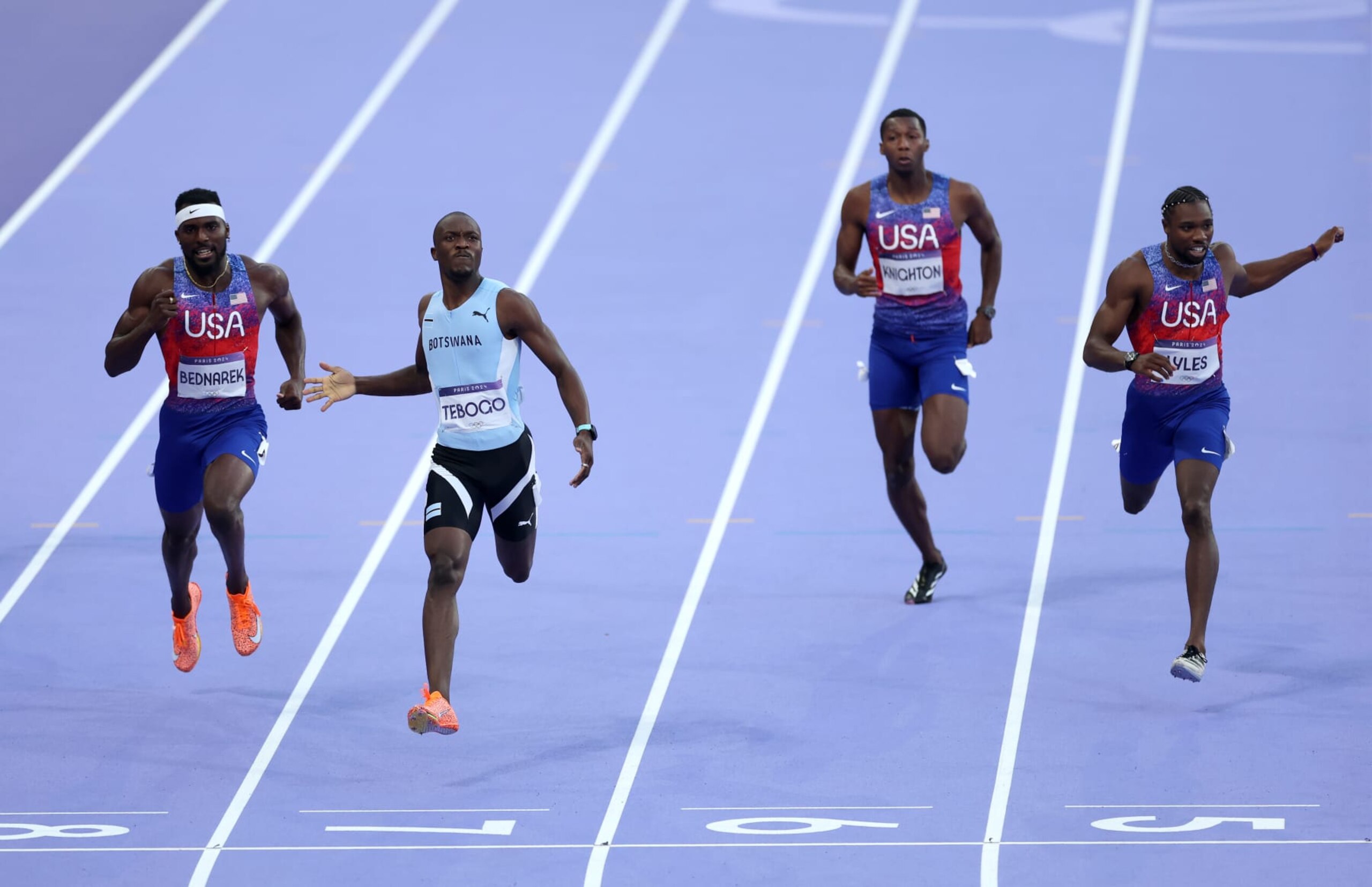 PARIS, FRANCE - AUGUST 08: Letsile Tebogo (C) of Team Botswana crosses the finish line to win the gold medal ahead of silver medalist Kenneth Bednarek of Team United States (L) and bronze medalist Noah Lyles of Team United States in the Men's 200m Final on day thirteen of the Olympic Games Paris 2024 at Stade de France on August 08, 2024 in Paris, France. (Photo by Michael Steele/Getty Images) PARIS, FRANCE - AUGUST 08: Letsile Tebogo (C) of Team Botswana crosses the finish line to win the gold medal ahead of silver medalist Kenneth Bednarek of Team United States (L) and bronze medalist Noah Lyles of Team United States in the Men's 200m Final on day thirteen of the Olympic Games Paris 2024 at Stade de France on August 08, 2024 in Paris, France. (Photo by Michael Steele/Getty Images)