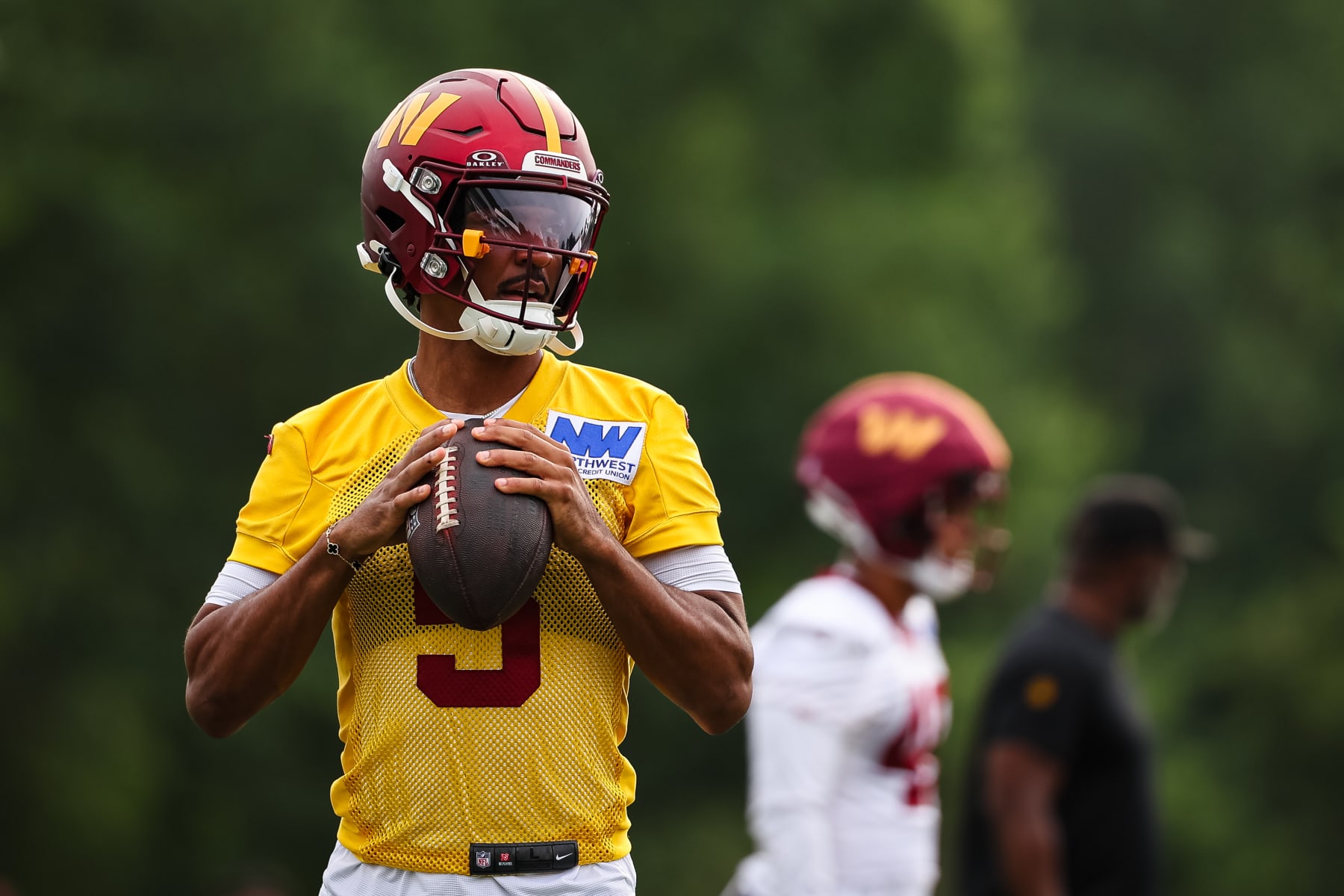 ASHBURN, VA - JULY 25: Jayden Daniels #5 of the Washington Commanders looks to pass during training camp at OrthoVirginia Training Center at Commanders Park on July 25, 2024 in Ashburn, Virginia. (Photo by Scott Taetsch/Getty Images)