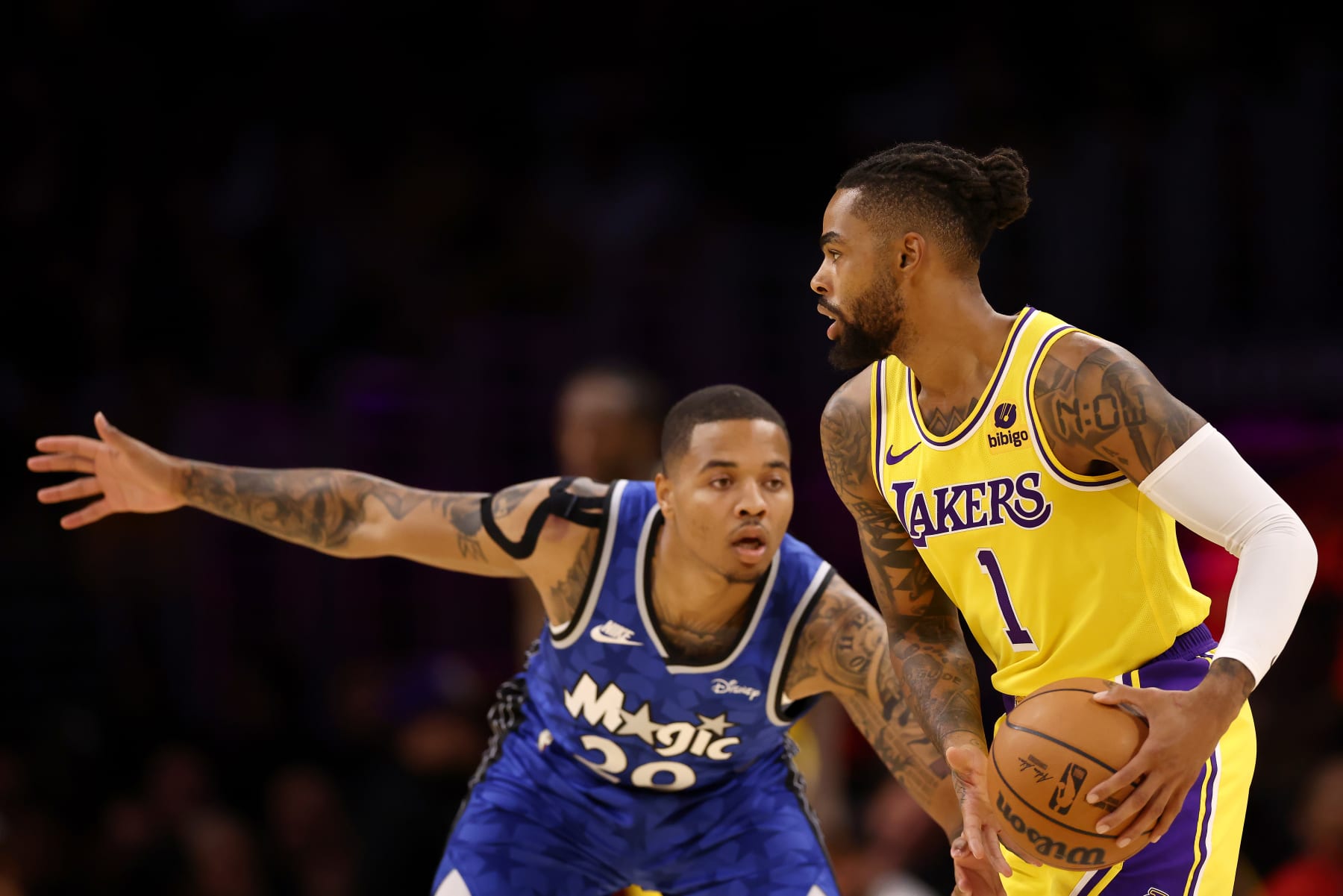 LOS ANGELES, CALIFORNIA - OCTOBER 30: D'Angelo Russell #1 of the Los Angeles Lakers looks to pass the ball against Markelle Fultz #20 of the Orlando Magic during the first quarter at Crypto.com Arena on October 30, 2023 in Los Angeles, California. NOTE TO USER: User expressly acknowledges and agrees that, by downloading and or using this photograph, User is consenting to the terms and conditions of the Getty Images License Agreement. (Photo by Katelyn Mulcahy/Getty Images)
