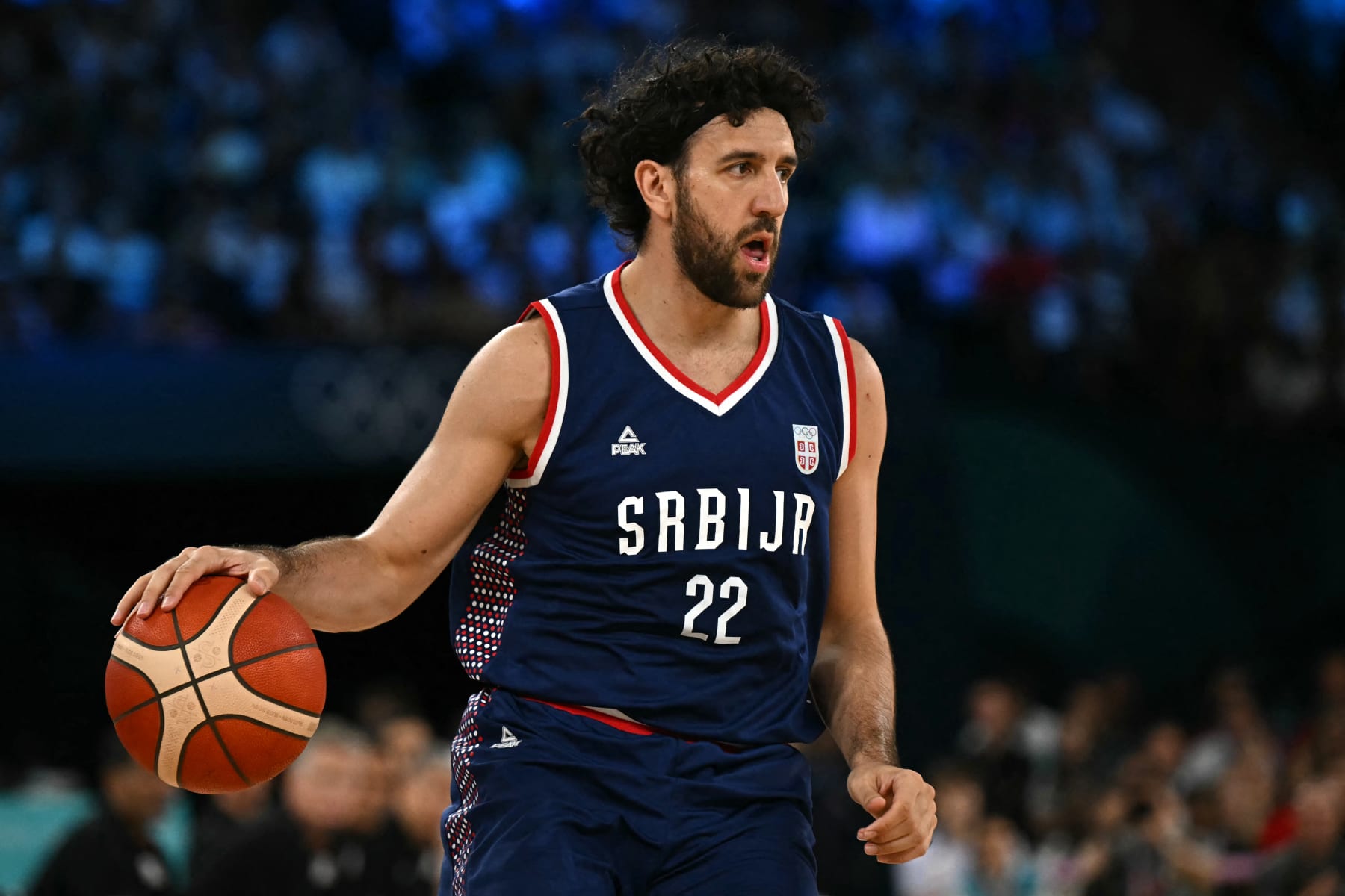 Serbia's #22 Vasilije Micic dribbles in the men's semifinal basketball match between USA and Serbia during the Paris 2024 Olympic Games at the Bercy  Arena in Paris on August 8, 2024. (Photo by Paul ELLIS / AFP) (Photo by PAUL ELLIS/AFP via Getty Images)