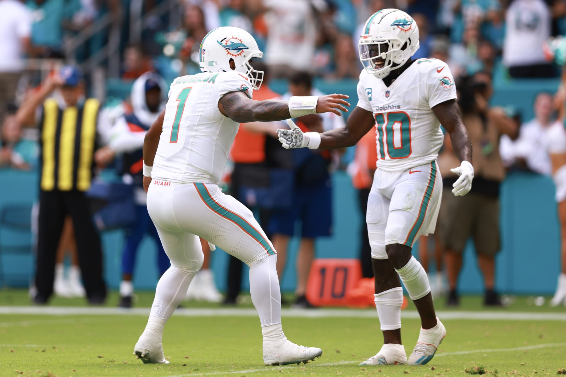 MIAMI GARDENS, FLORIDA - SEPTEMBER 24: Tua Tagovailoa #1 of the Miami Dolphins and Tyreek Hill #10 of the Miami Dolphins celebrate after a Miami touchdown during the third quarter against the Denver Broncos at Hard Rock Stadium on September 24, 2023 in Miami Gardens, Florida. (Photo by Megan Briggs/Getty Images)