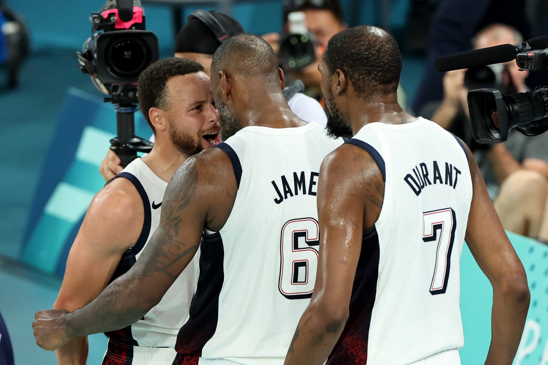 PARIS, FRANCE - AUGUST 08: Lebron James #6 and Stephen Curry #4 of Team United States react after winning a Men's basketball semifinals match between Team United States and Team Serbia on day thirteen of the Olympic Games Paris 2024 at Bercy Arena on August 08, 2024 in Paris, France. (Photo by Arturo Holmes/Getty Images) PARIS, FRANCE - AUGUST 08: Lebron James #6 and Stephen Curry #4 of Team United States react after winning a Men's basketball semifinals match between Team United States and Team Serbia on day thirteen of the Olympic Games Paris 2024 at Bercy Arena on August 08, 2024 in Paris, France. (Photo by Arturo Holmes/Getty Images)