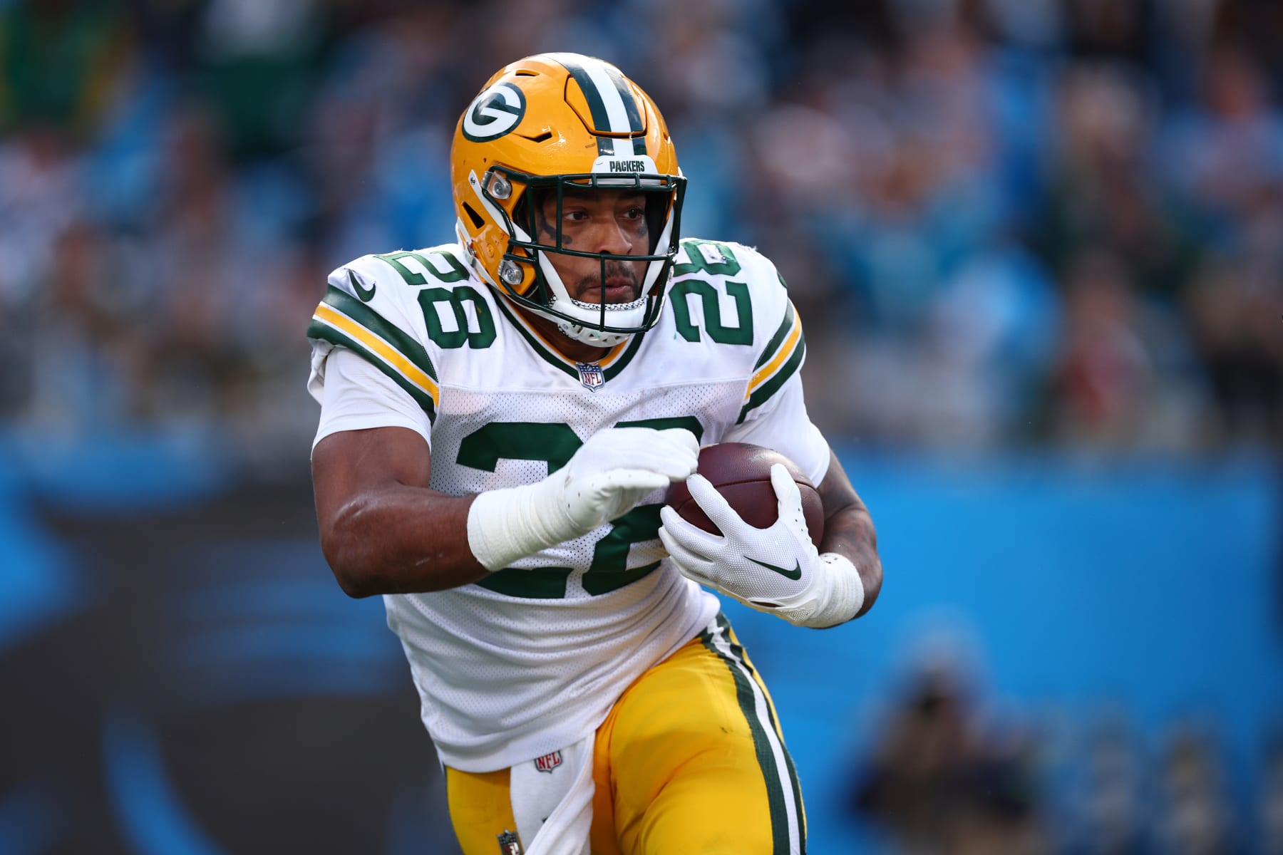 CHARLOTTE, NORTH CAROLINA - DECEMBER 24: AJ Dillon #28 of the Green Bay Packers carries the ball during the second half of the game against the Carolina Panthers at Bank of America Stadium on December 24, 2023 in Charlotte, North Carolina. (Photo by Jared C. Tilton/Getty Images)