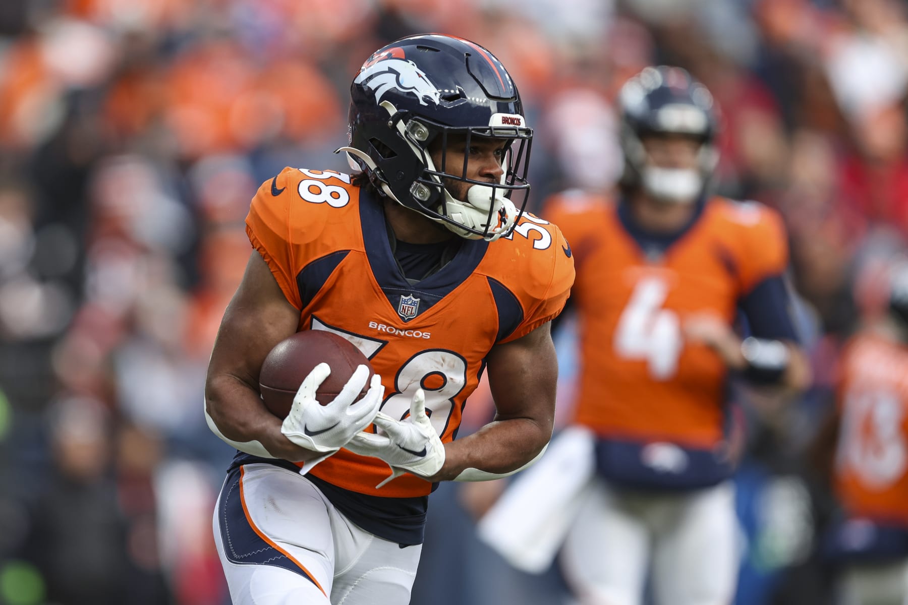 DENVER, CO - DECEMBER 31: Jaleel McLaughlin #38 of the Denver Broncos runs the ball during an NFL football game against the Los Angeles Chargers at Empower Field at Mile High on December 31, 2023 in Denver, Colorado. (Photo by Perry Knotts/Getty Images)