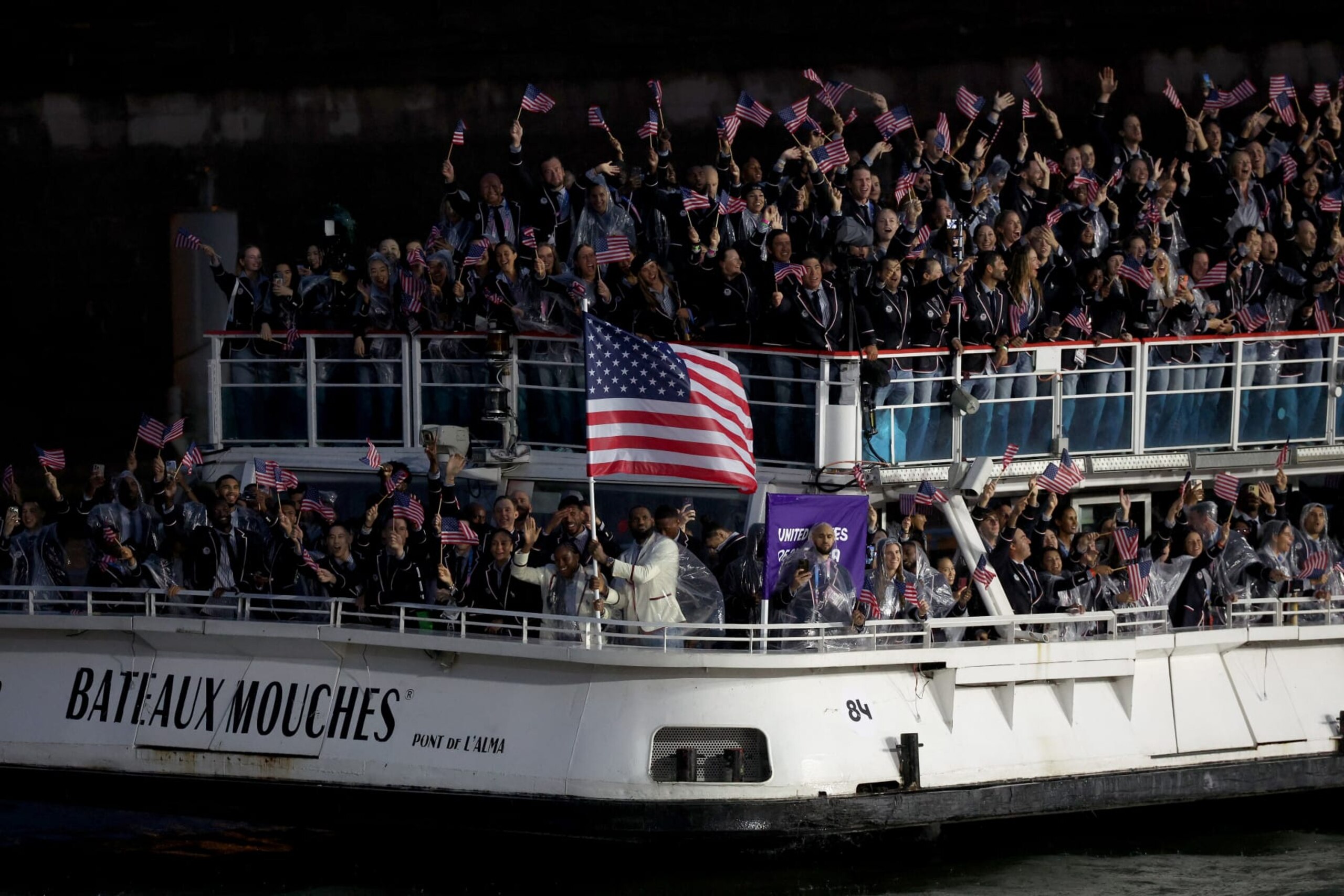 PARIS, FRANCE - JULY 26: Coco Gauff and Lebron James, Flagbearers of Team United States, are seen on a boat waving their flag along the River Seine during the opening ceremony of the Olympic Games Paris 2024 on July 26, 2024 in Paris, France. (Photo by Alex Broadway/Getty Images)