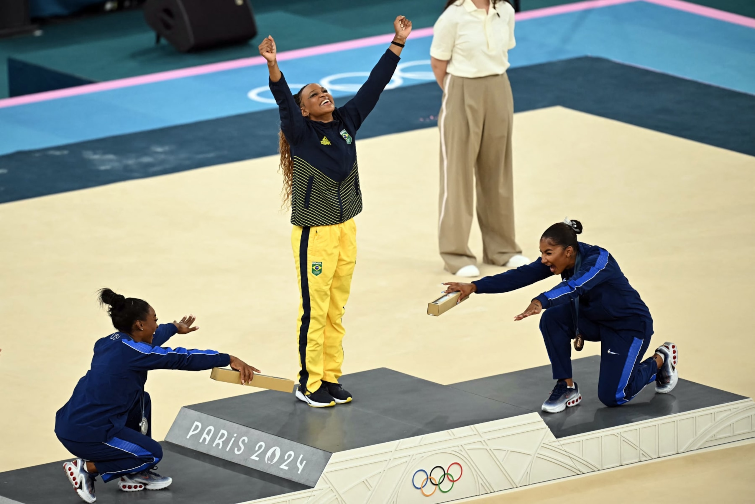 (LtoR) US' Simone Biles (silver), Brazil's Rebeca Andrade (gold) and US' Jordan Chiles (bronze) pose during the podium ceremony for the artistic gymnastics women's floor exercise event of the Paris 2024 Olympic Games at the Bercy Arena in Paris, on August 5, 2024. (Photo by Paul ELLIS / AFP) (Photo by PAUL ELLIS/AFP via Getty Images)