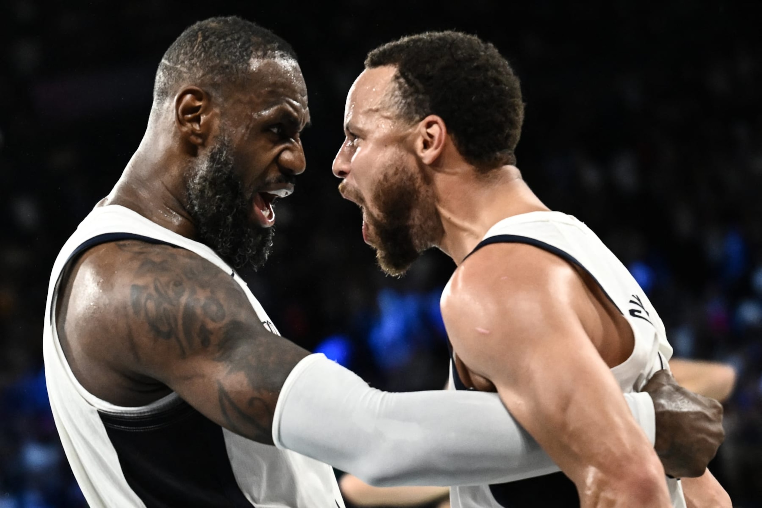 USA's #06 LeBron James (L) celebrates with USA's #04 Stephen Curry at the end of the men's semifinal basketball match between USA and Serbia during the Paris 2024 Olympic Games at the Bercy  Arena in Paris on August 8, 2024. (Photo by Aris MESSINIS / AFP) (Photo by ARIS MESSINIS/AFP via Getty Images)