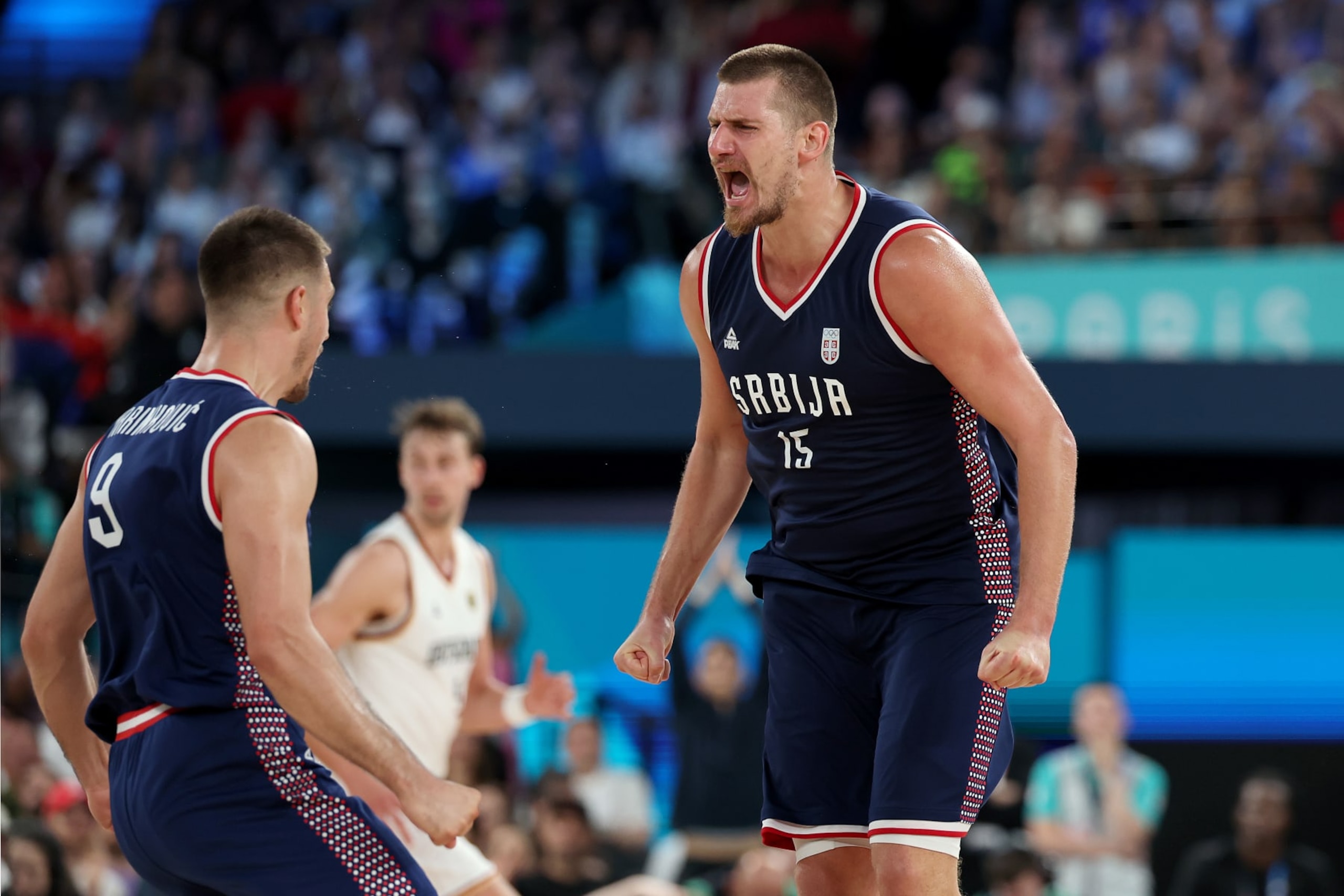 PARIS, FRANCE - AUGUST 10: Nikola Jokic #15 of Team Serbia celebrates with teammate Vanja Marinkovic #9 after scoring during the Men's Bronze Medal Game between Team Germany and Team Serbia on day fifteen of the Olympic Games Paris 2024 at Bercy Arena on August 10, 2024 in Paris, France. (Photo by Gregory Shamus/Getty Images)