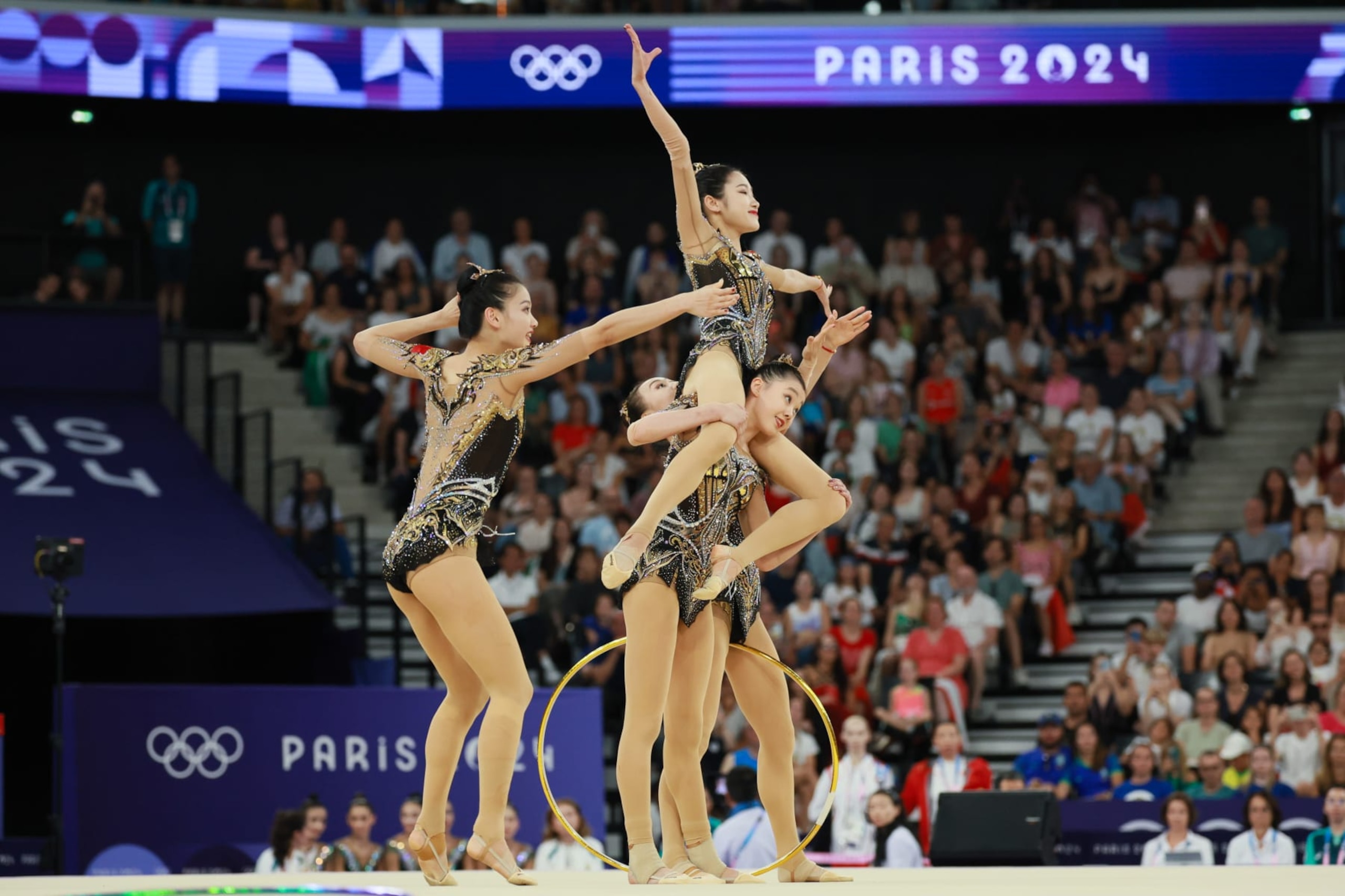 PARIS, FRANCE - AUGUST 10: Gymnasts of Team China compete during the Rhythmic Gymnastics - Group All-Around Final on day 15 of the Paris 2024 Olympic Games at the Porte de la Chapelle Arena on August 10, 2024 in Paris, France. (Photo by Lu Lin/CHINASPORTS/VCG via Getty Images)