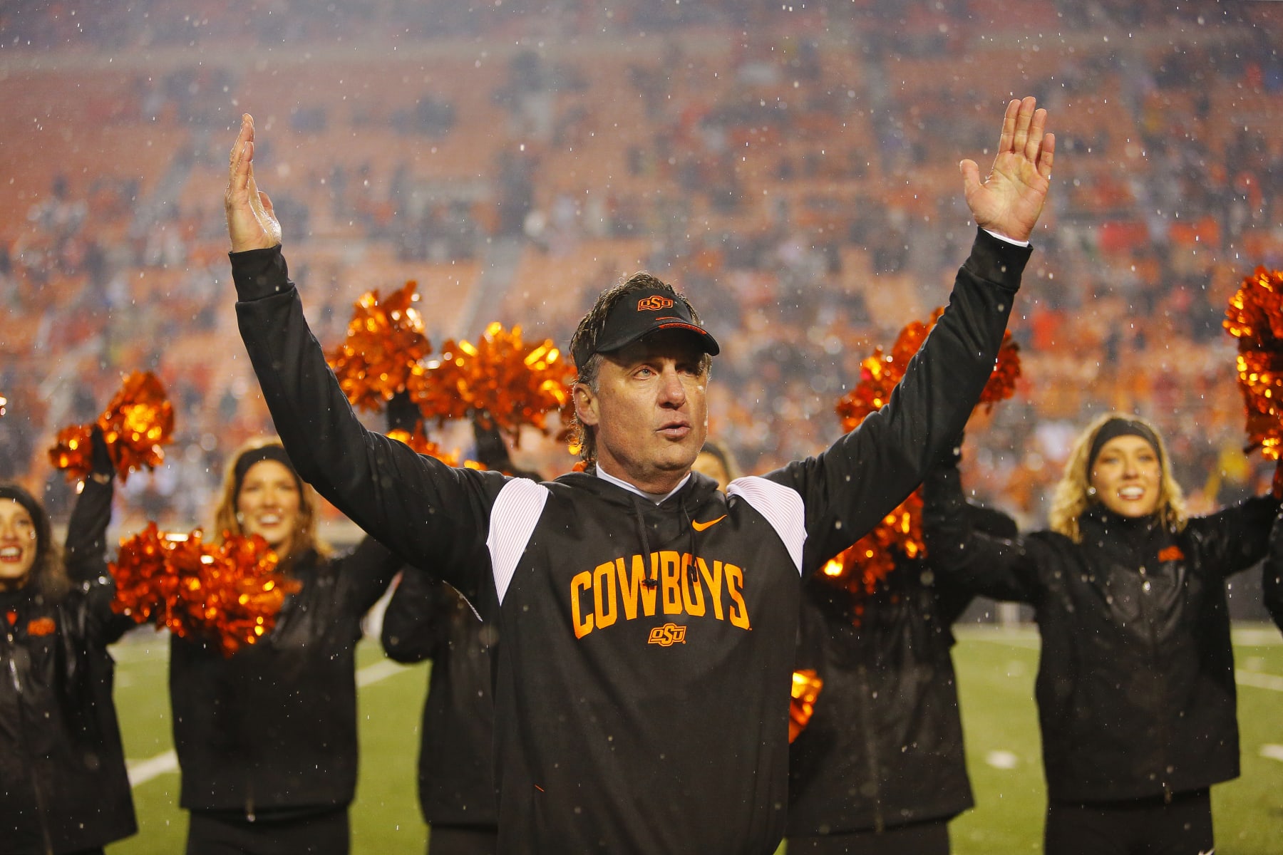 STILLWATER, OK - NOVEMBER 25:  Head coach Mike Gundy of the Oklahoma State Cowboys celebrates a win over the BYU Cougars with the "U" in OSU after their game at Boone Pickens Stadium on November 25, 2023 in Stillwater, Oklahoma.  Oklahoma State won 40-34 in double overtime.  (Photo by Brian Bahr/Getty Images)